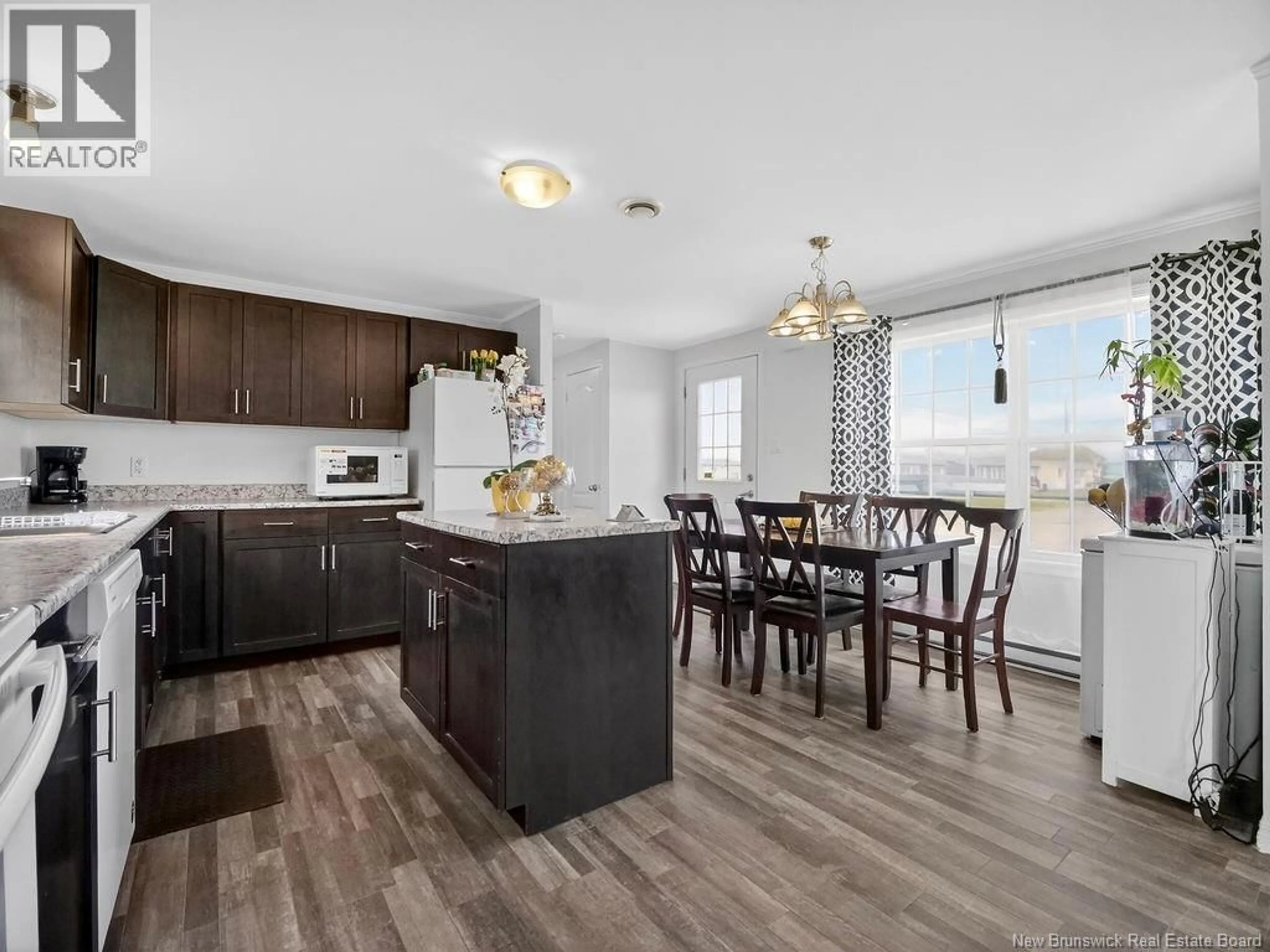 Open concept kitchen, wood/laminate floor for 19 RUE ANNA, Bas Cap Pele New Brunswick E4N0E3