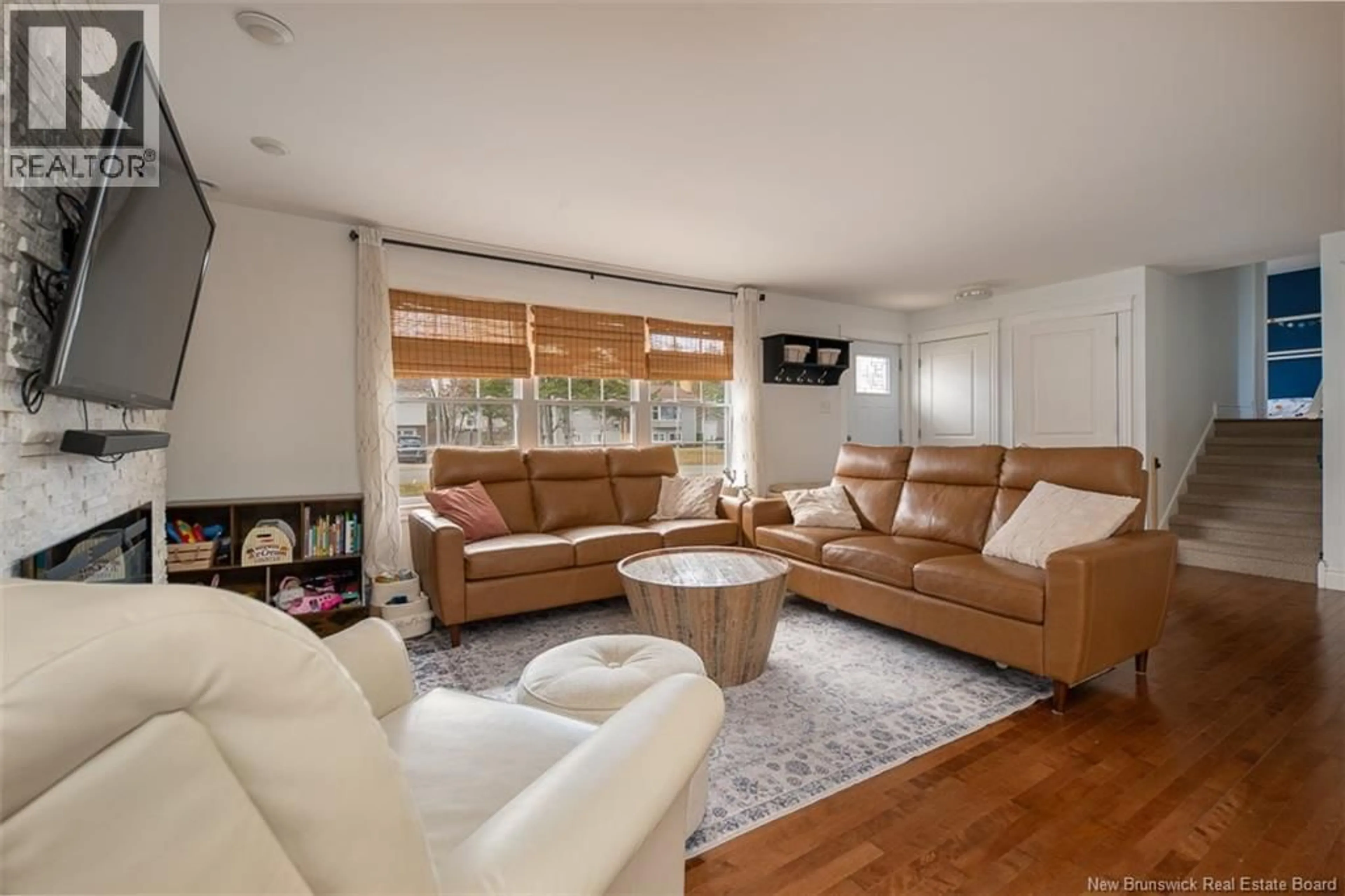 Living room with furniture, wood/laminate floor for 86 BERKLEY DRIVE, New Maryland New Brunswick E3C1C4