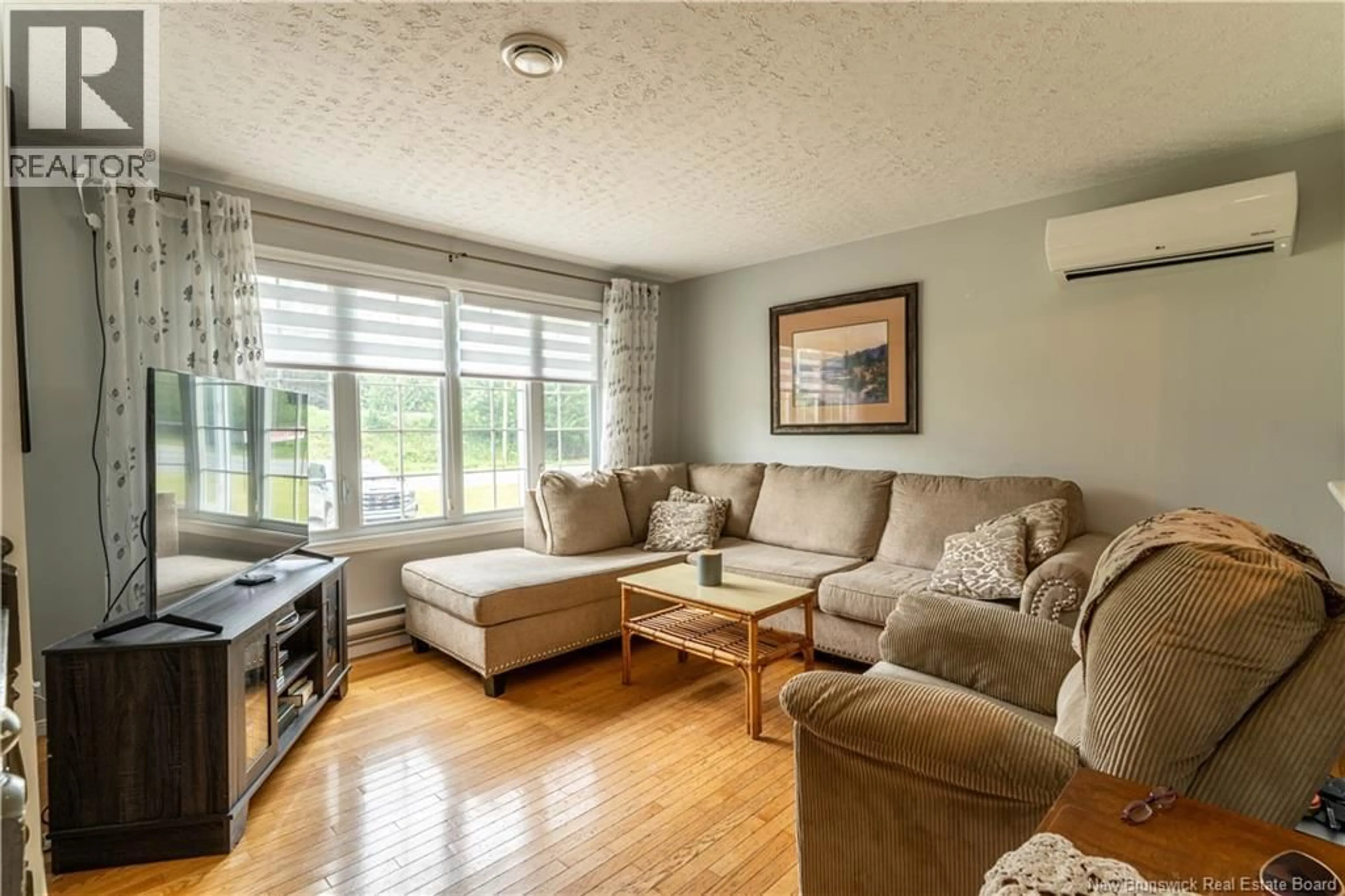 Living room with furniture, wood/laminate floor for 11235 RUE PRINCIPALE, Rogersville New Brunswick E4Y2N7