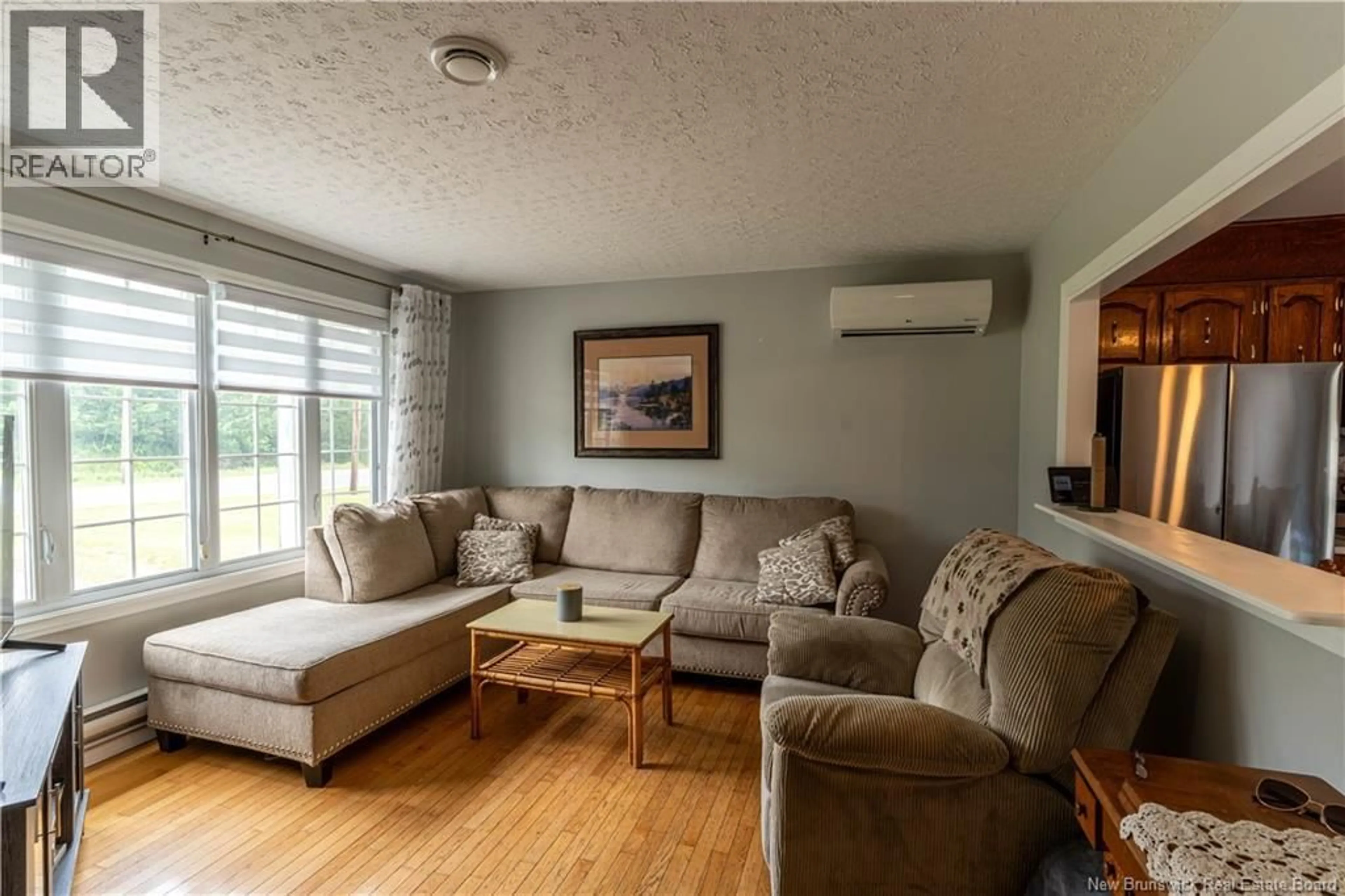 Living room with furniture, wood/laminate floor for 11235 RUE PRINCIPALE, Rogersville New Brunswick E4Y2N7