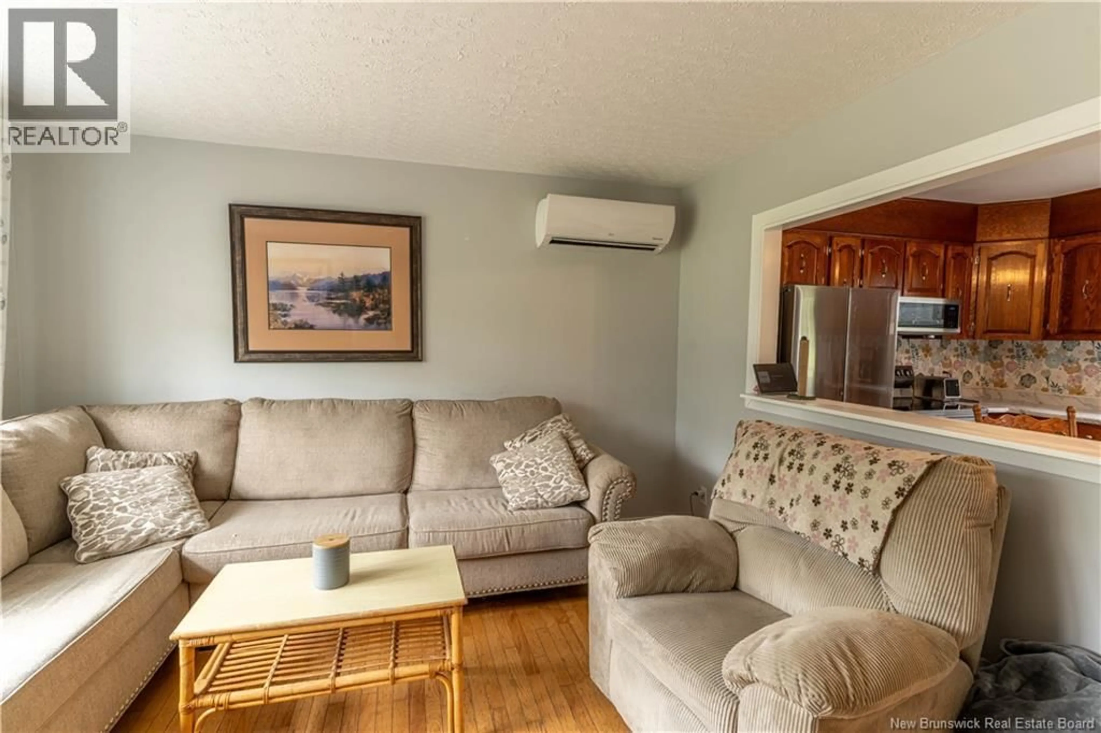 Living room with furniture, wood/laminate floor for 11235 RUE PRINCIPALE, Rogersville New Brunswick E4Y2N7