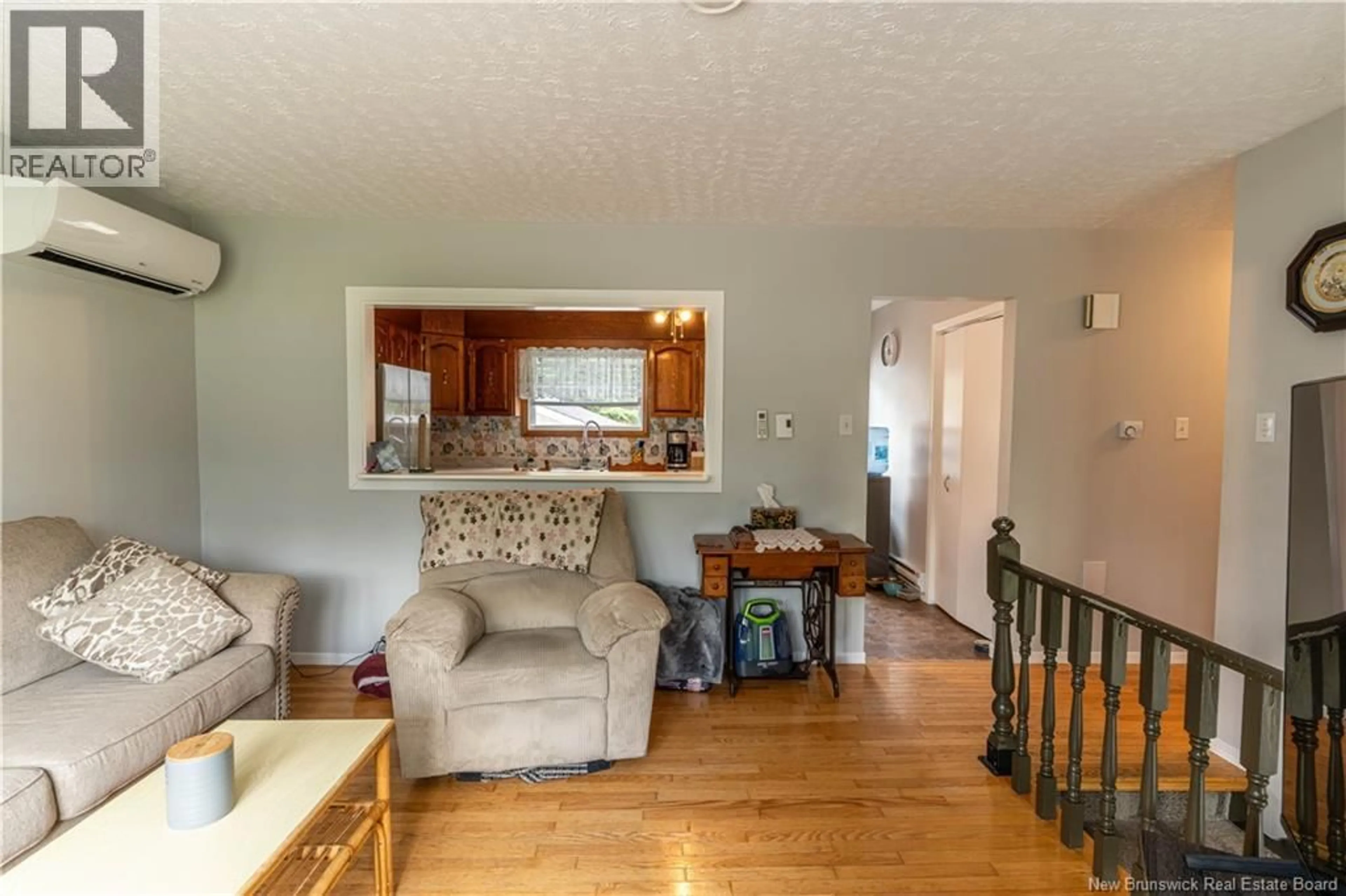 Living room with furniture, wood/laminate floor for 11235 RUE PRINCIPALE, Rogersville New Brunswick E4Y2N7