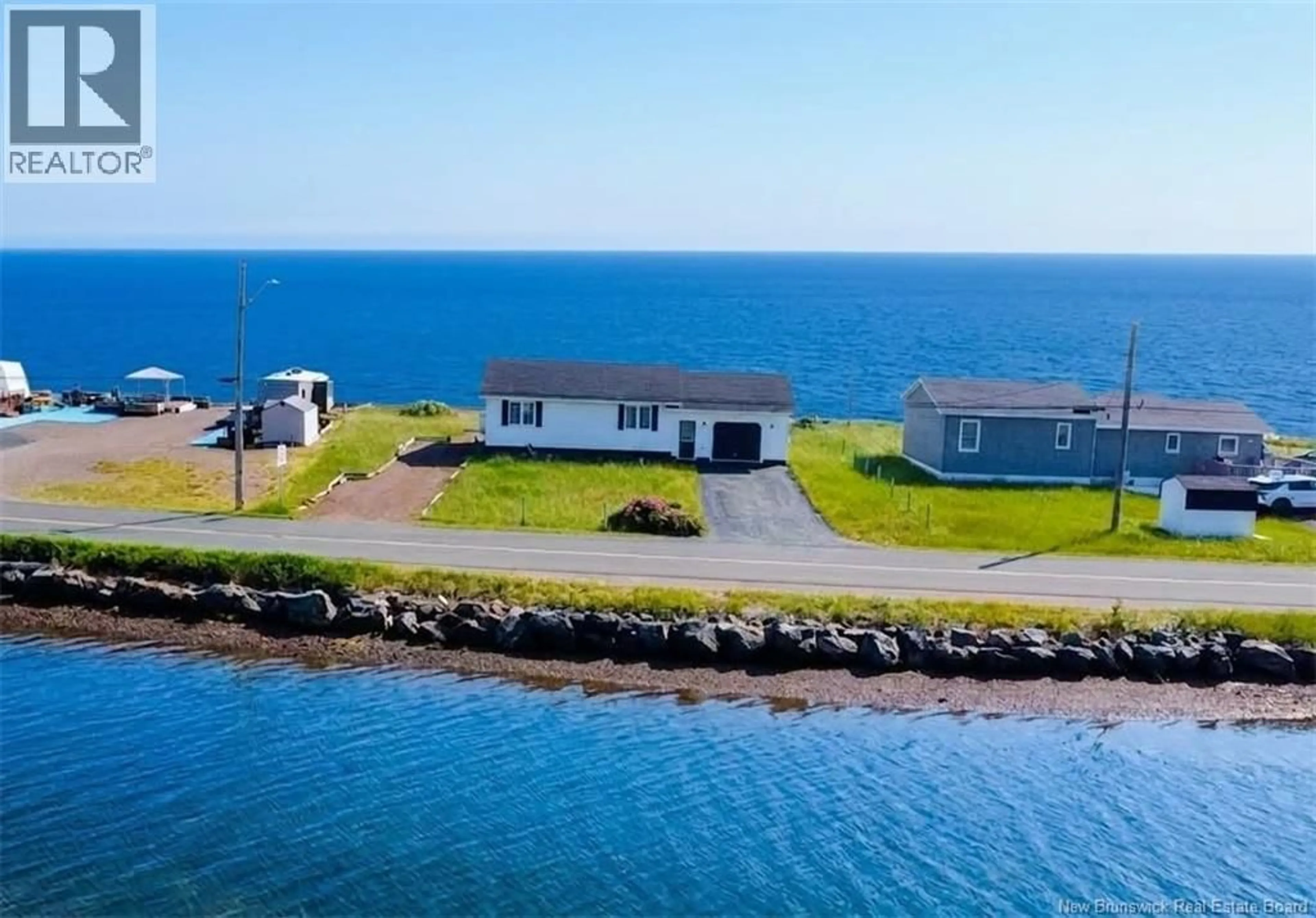 A pic from outside/outdoor area/front of a property/back of a property/a pic from drone, water/lake/river/ocean view for 915 JOHN CORMIER, Beresford New Brunswick E8K1W2