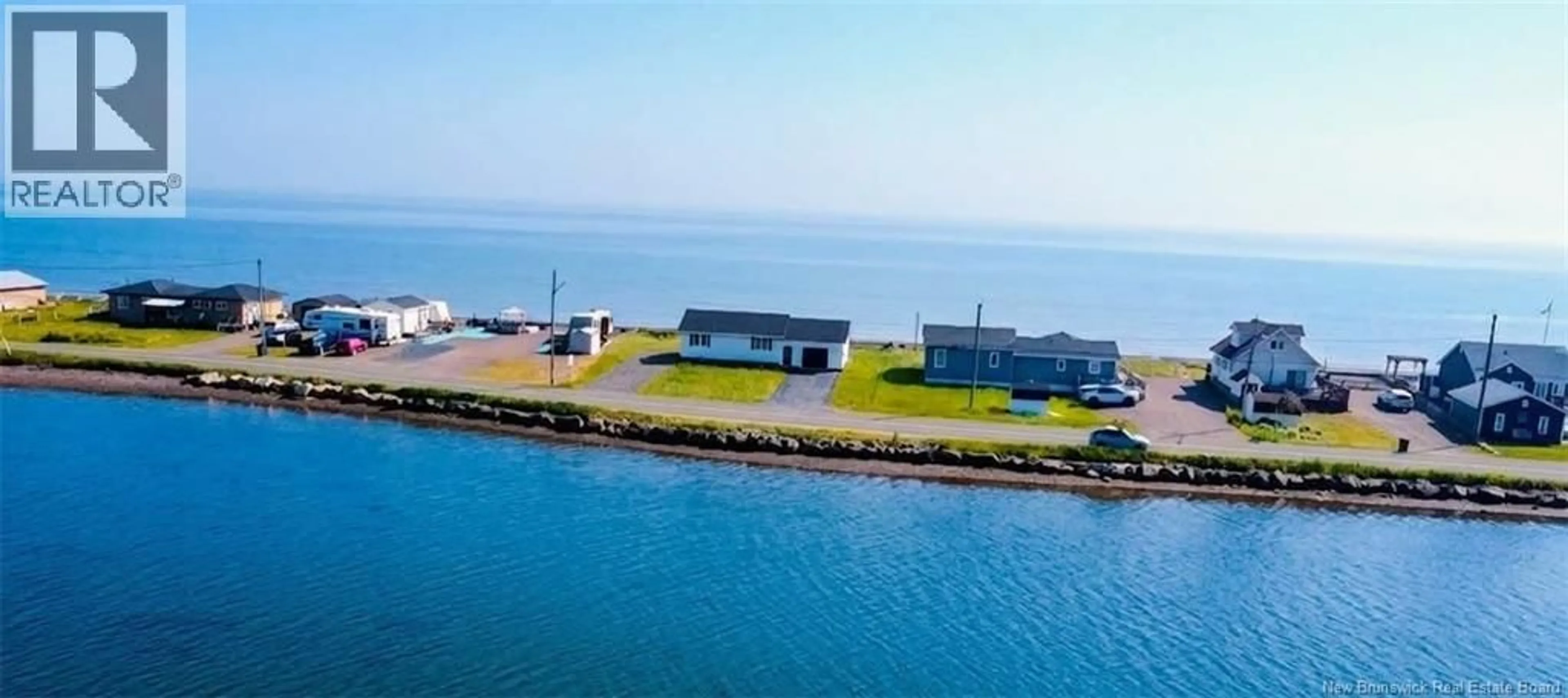 A pic from outside/outdoor area/front of a property/back of a property/a pic from drone, water/lake/river/ocean view for 915 JOHN CORMIER, Beresford New Brunswick E8K1W2