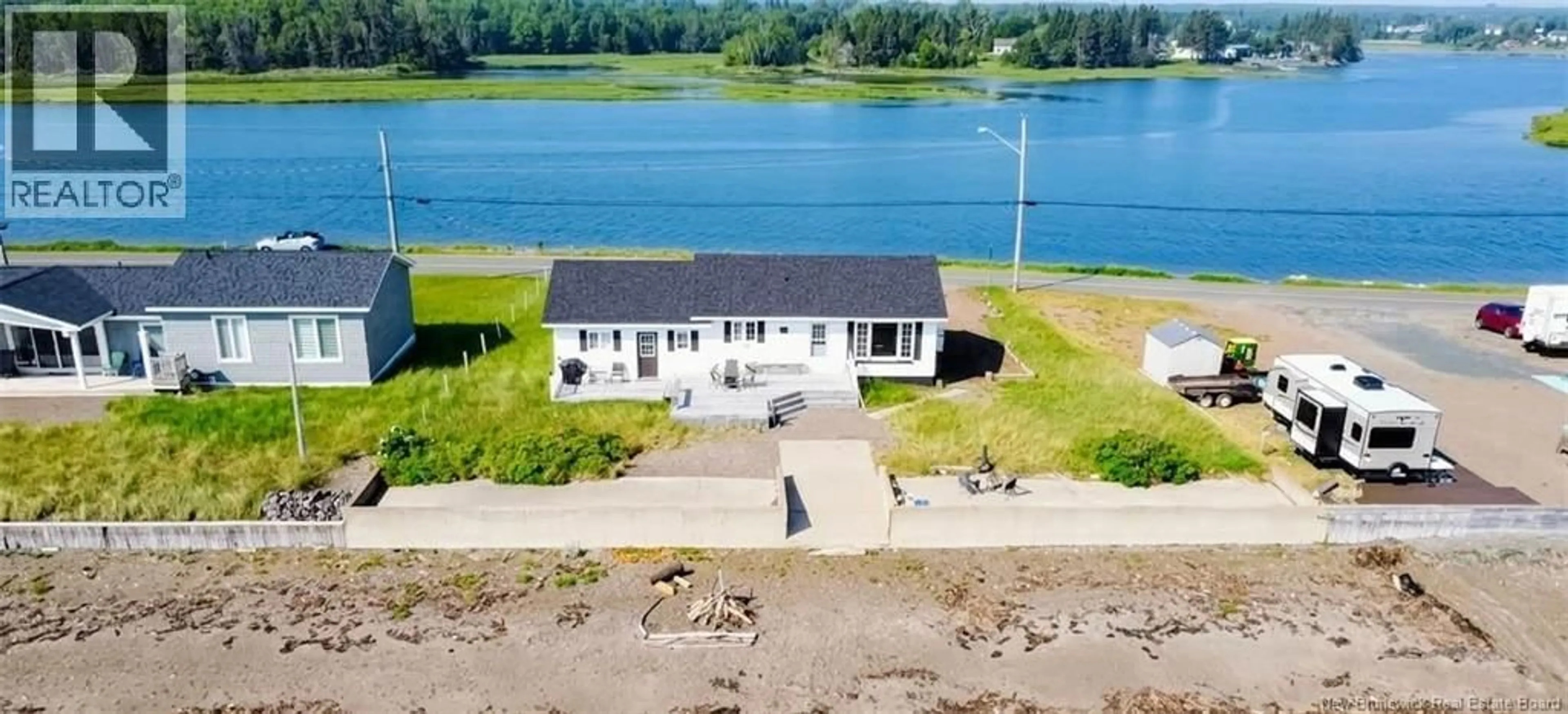 A pic from outside/outdoor area/front of a property/back of a property/a pic from drone, water/lake/river/ocean view for 915 JOHN CORMIER, Beresford New Brunswick E8K1W2