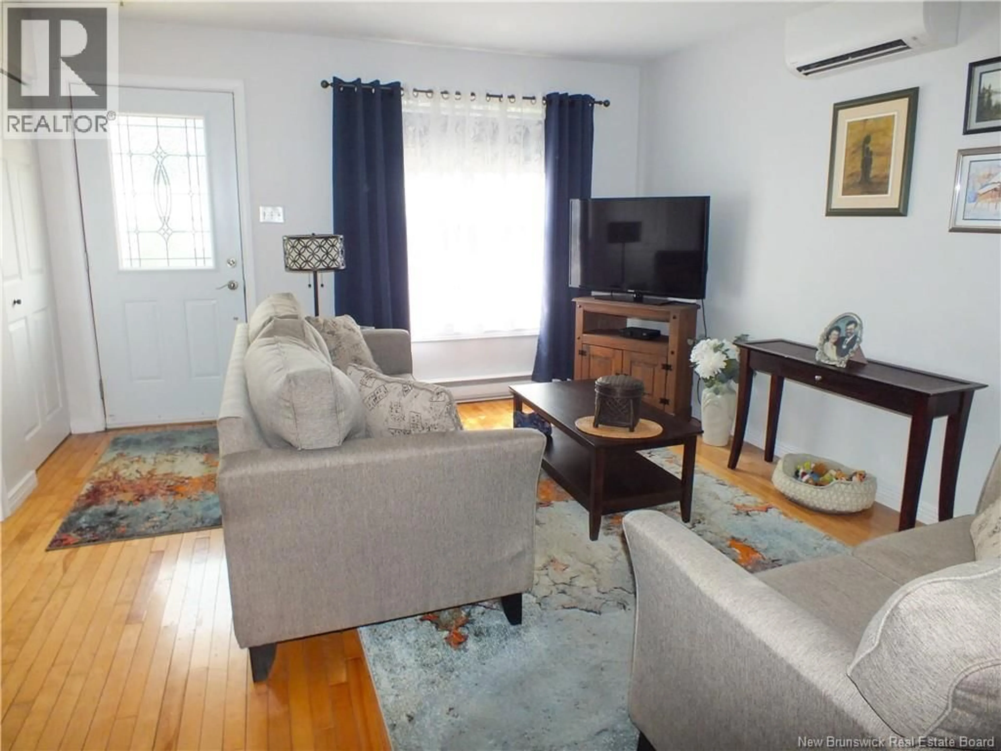 Living room with furniture, wood/laminate floor for 121 CREIGHTON STREET, Woodstock New Brunswick E7M1N4