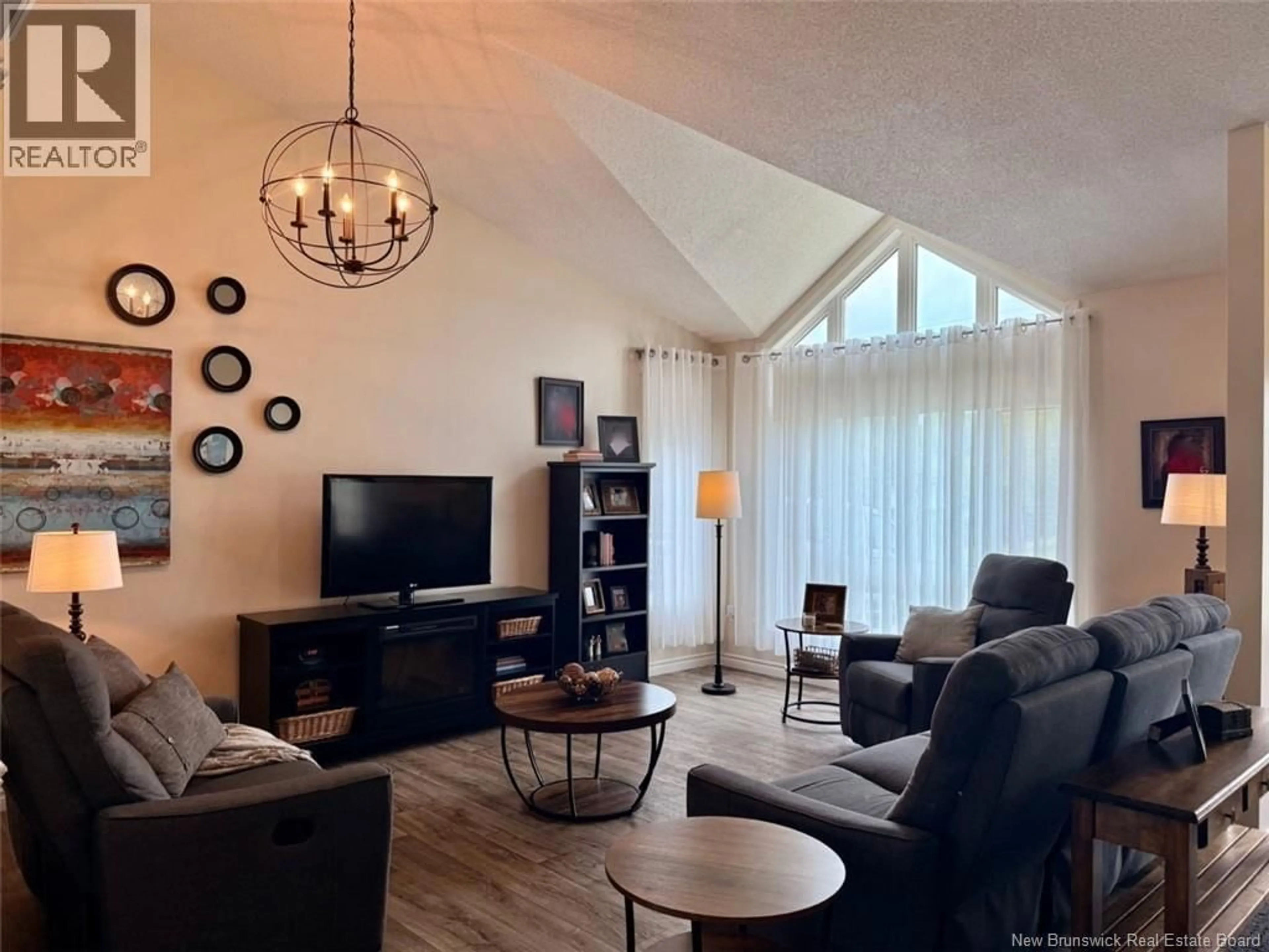 Living room with furniture, wood/laminate floor for 18 SAVOIE STREET, Balmoral New Brunswick E8E1J9