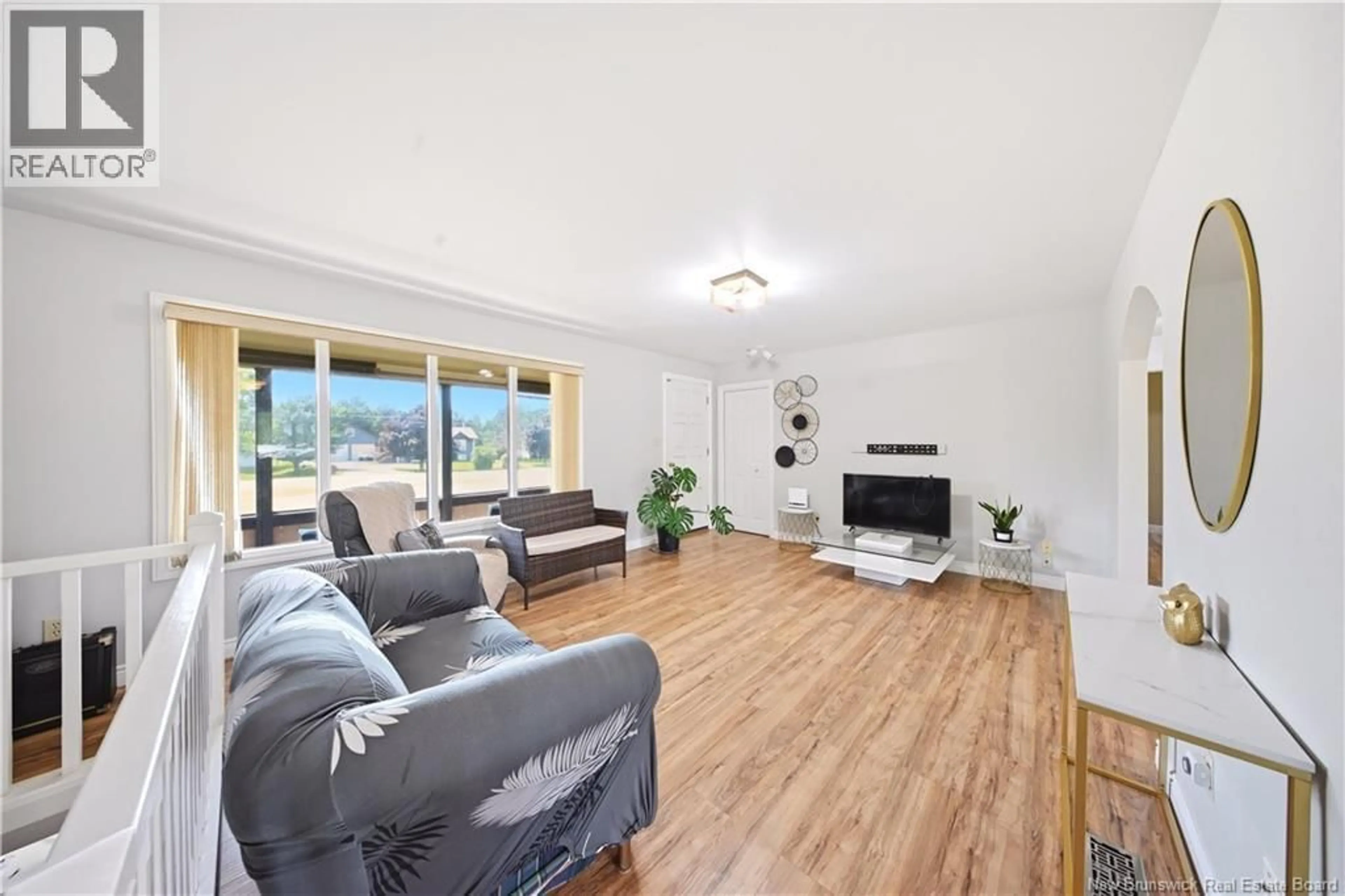 Living room with furniture, wood/laminate floor for 283 ROBICHAUD, Cap-Pelé New Brunswick E4N1Y6