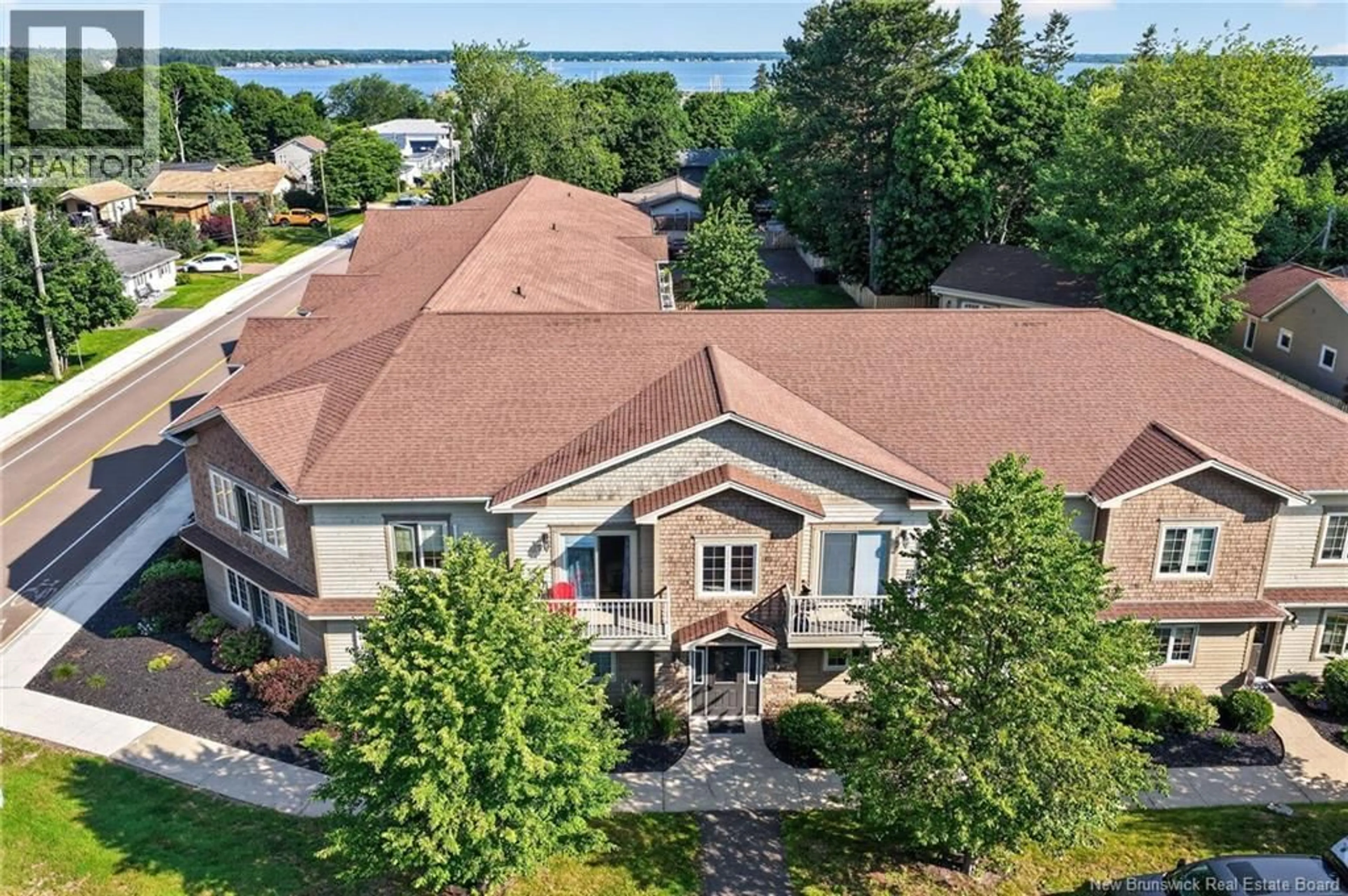 A pic from outside/outdoor area/front of a property/back of a property/a pic from drone, water/lake/river/ocean view for 208 - 98 PLEASANT STREET, Shediac New Brunswick E4P2L6