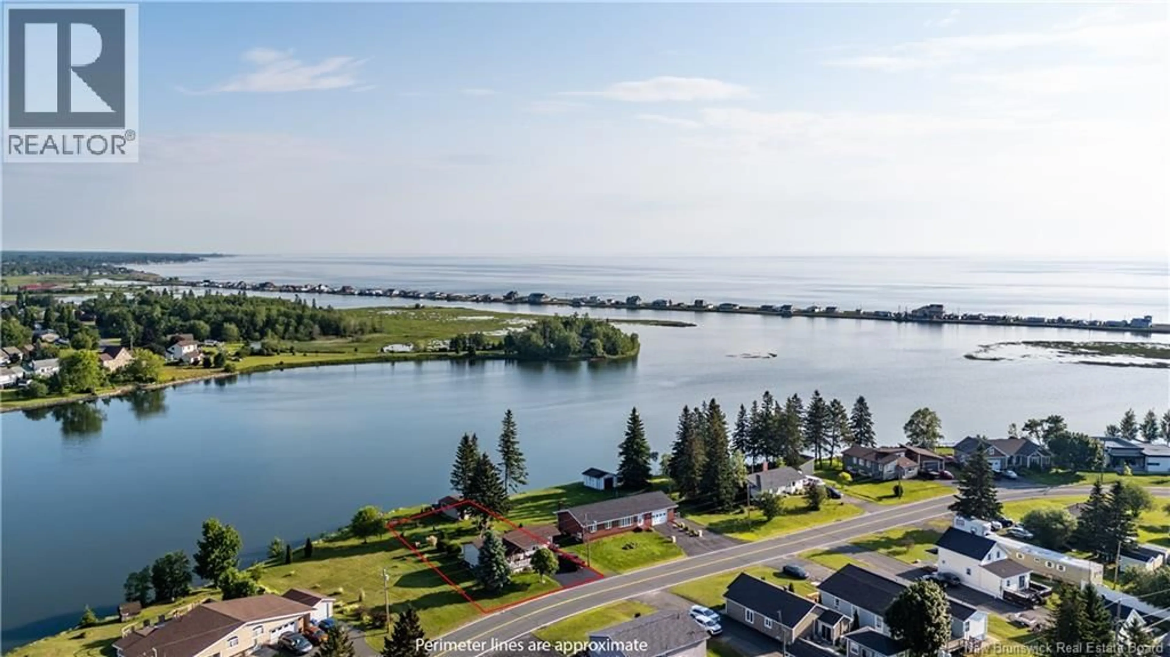 A pic from outside/outdoor area/front of a property/back of a property/a pic from drone, water/lake/river/ocean view for 101 RUE MARIE, Beresford New Brunswick E8K1P8
