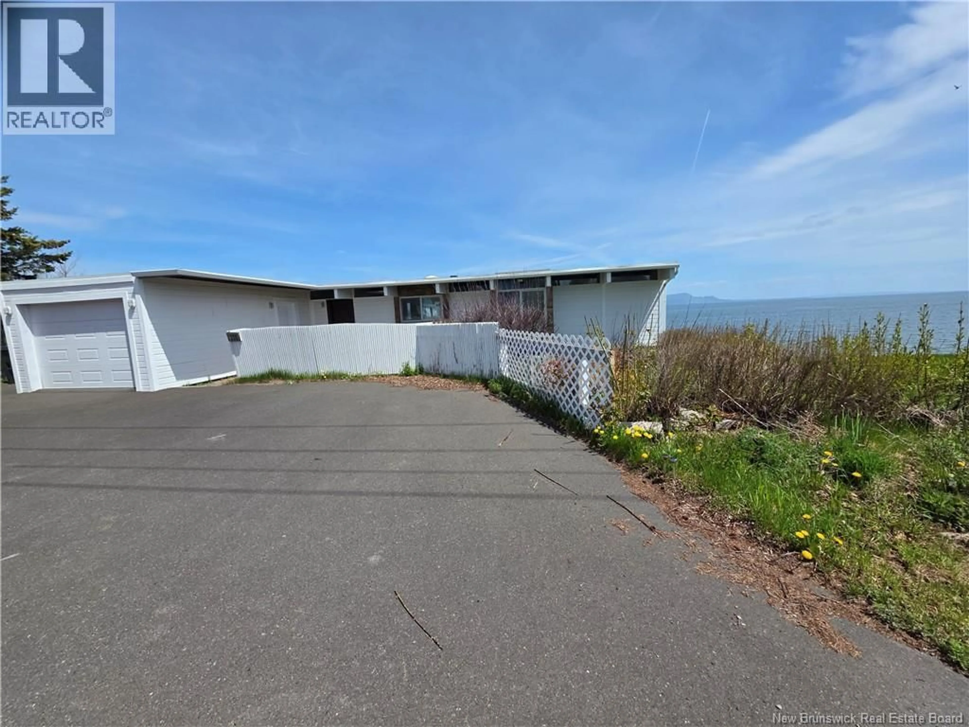 A pic from outside/outdoor area/front of a property/back of a property/a pic from drone, water/lake/river/ocean view for 255 CHALEUR, Charlo New Brunswick E8E2B8
