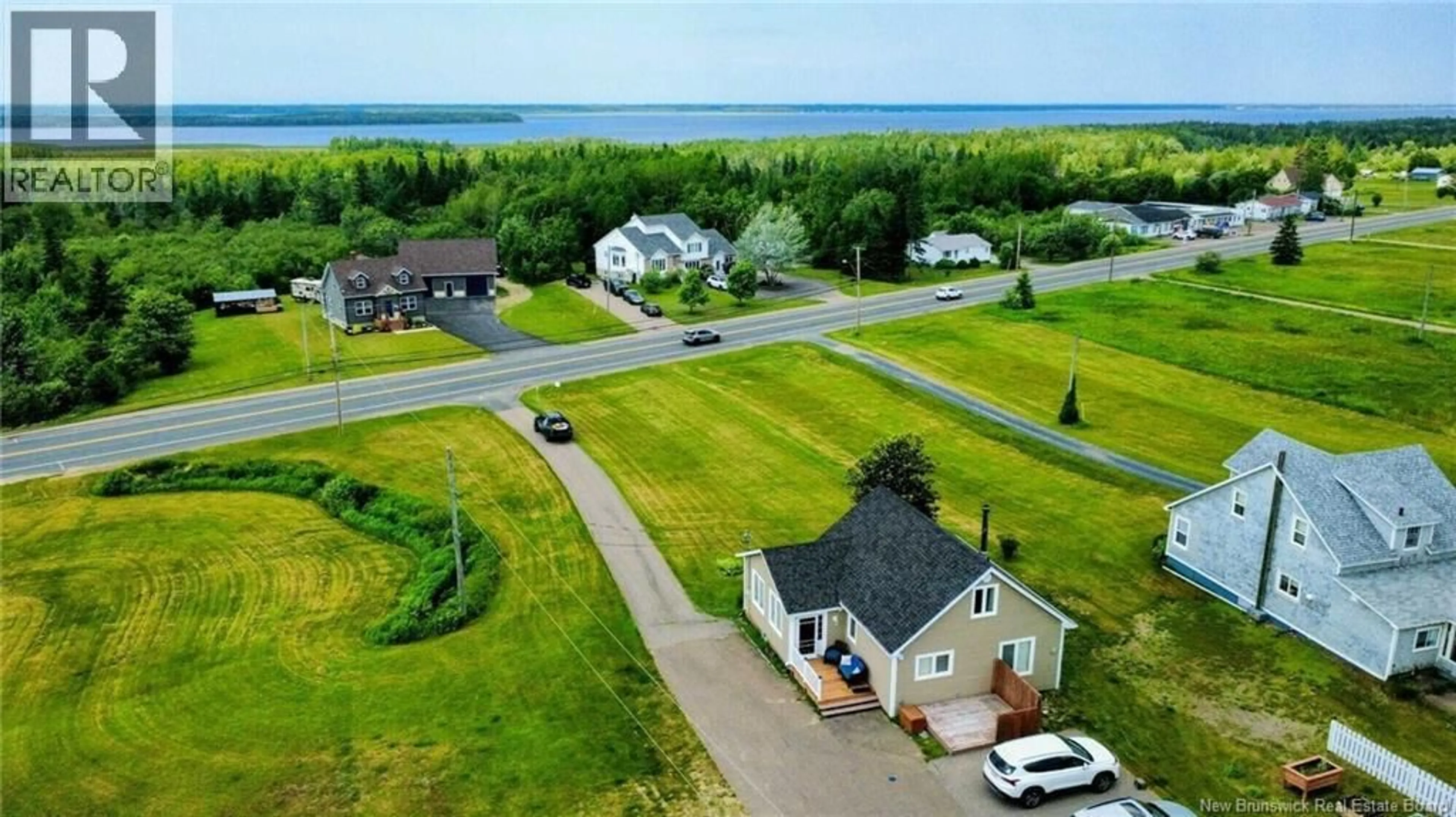 A pic from outside/outdoor area/front of a property/back of a property/a pic from drone, water/lake/river/ocean view for 879 BD DES ACADIENS, Bertrand New Brunswick E1W1H5