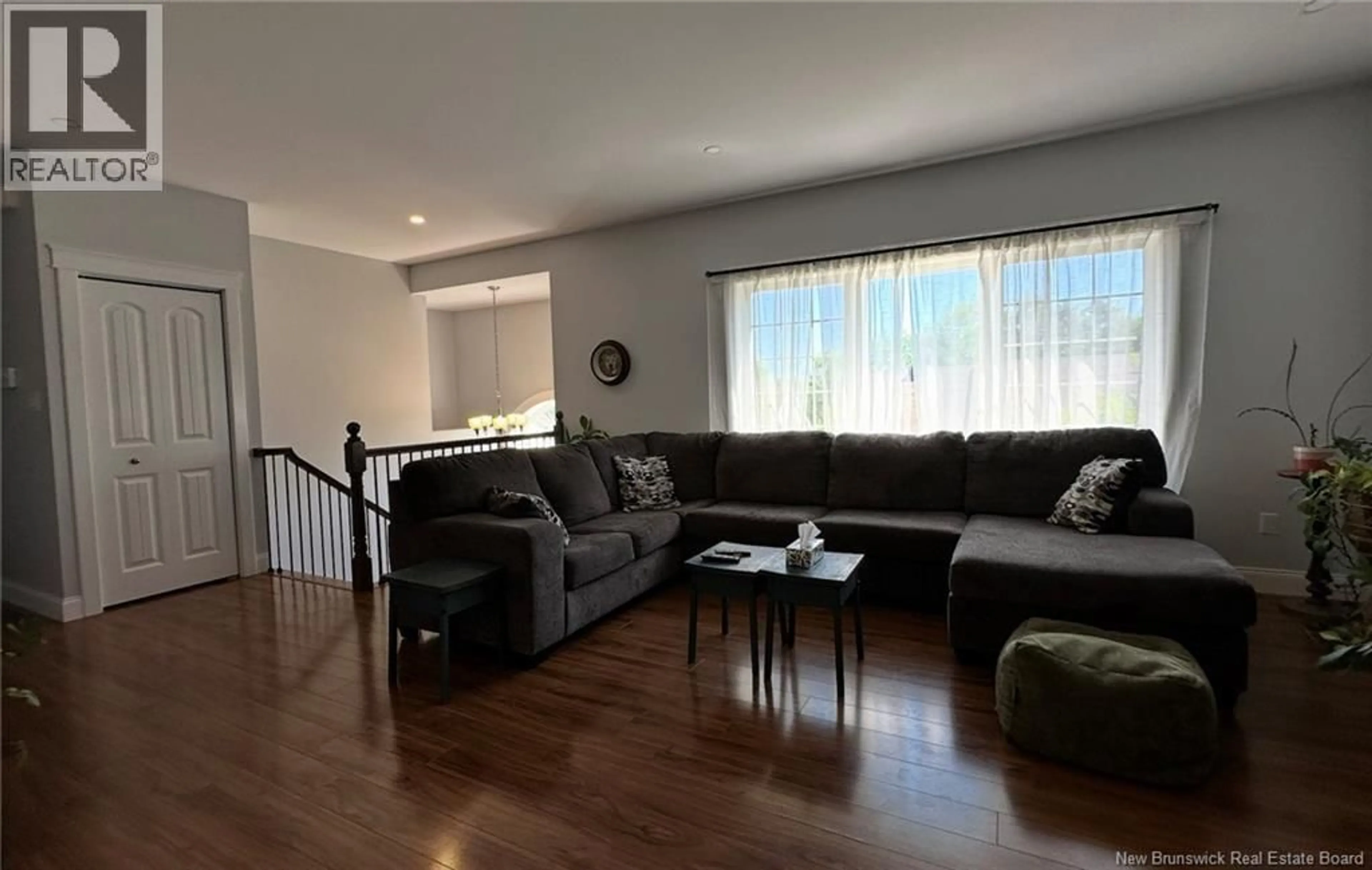 Living room with furniture, wood/laminate floor for 25 HELENA COURT, Fredericton New Brunswick E3B0E2