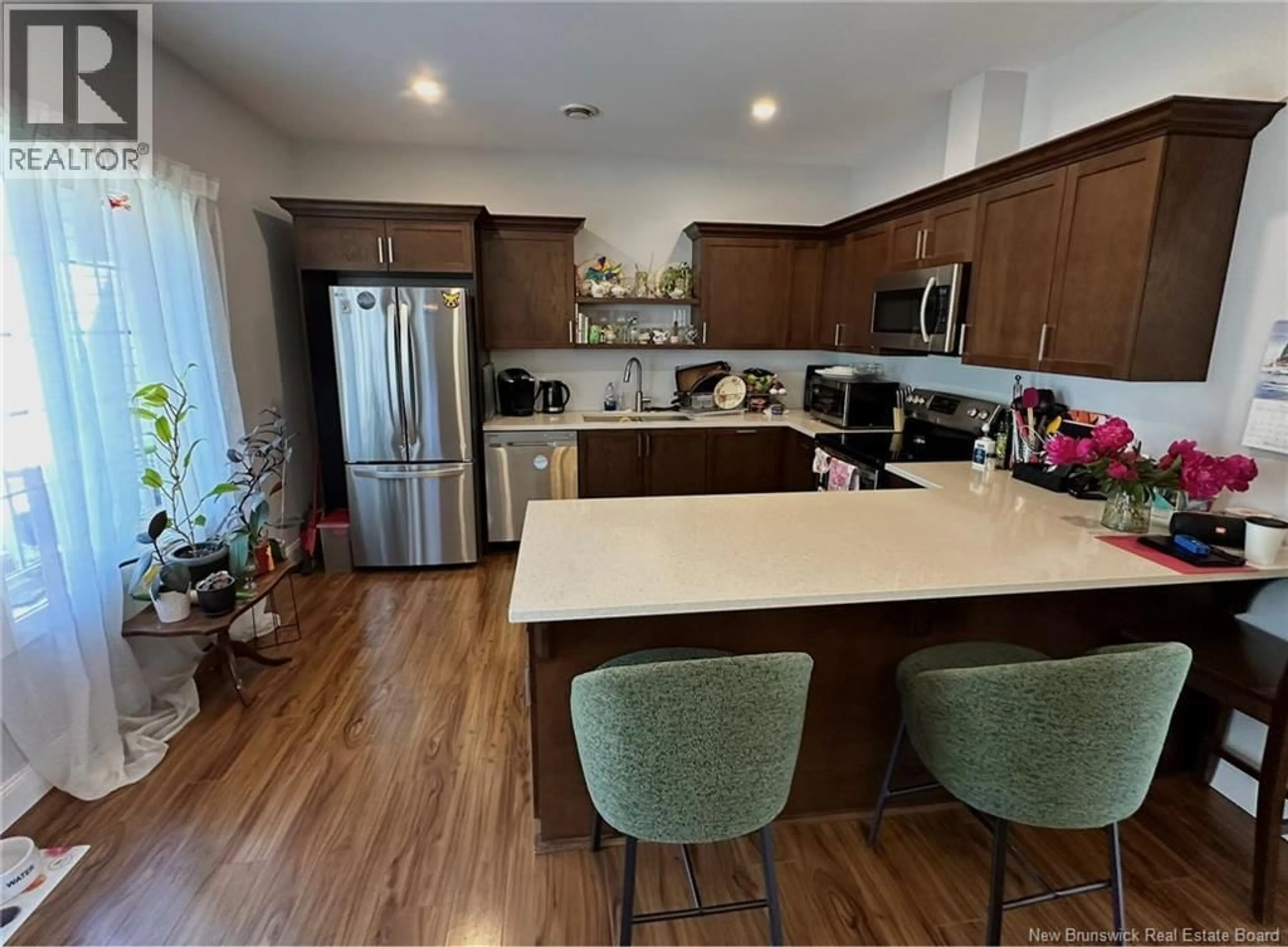 Open concept kitchen, wood/laminate floor for 25 HELENA COURT, Fredericton New Brunswick E3B0E2