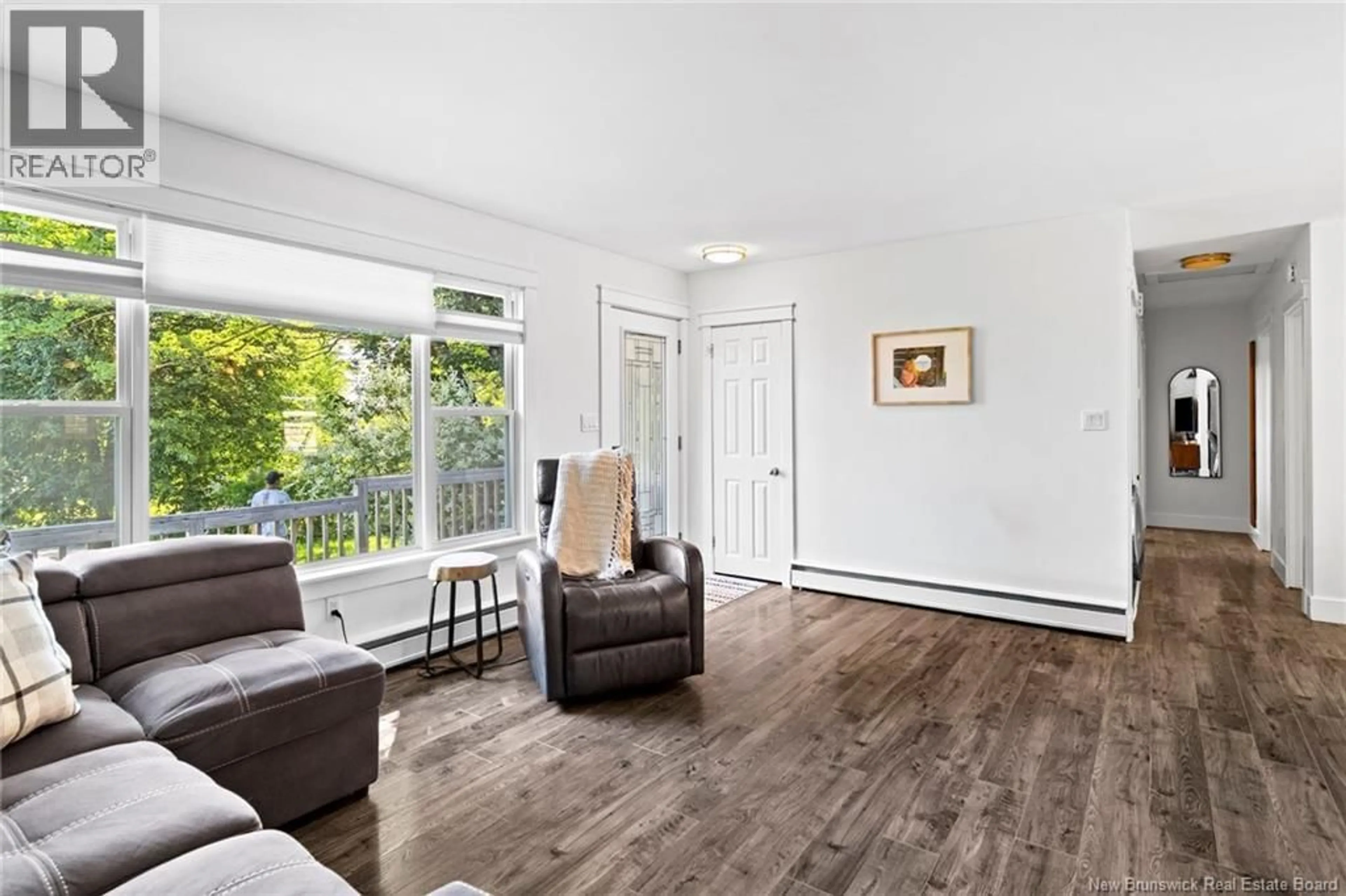 Living room with furniture, wood/laminate floor for 26 CHELSEA COURT, Fredericton New Brunswick E3B4N1