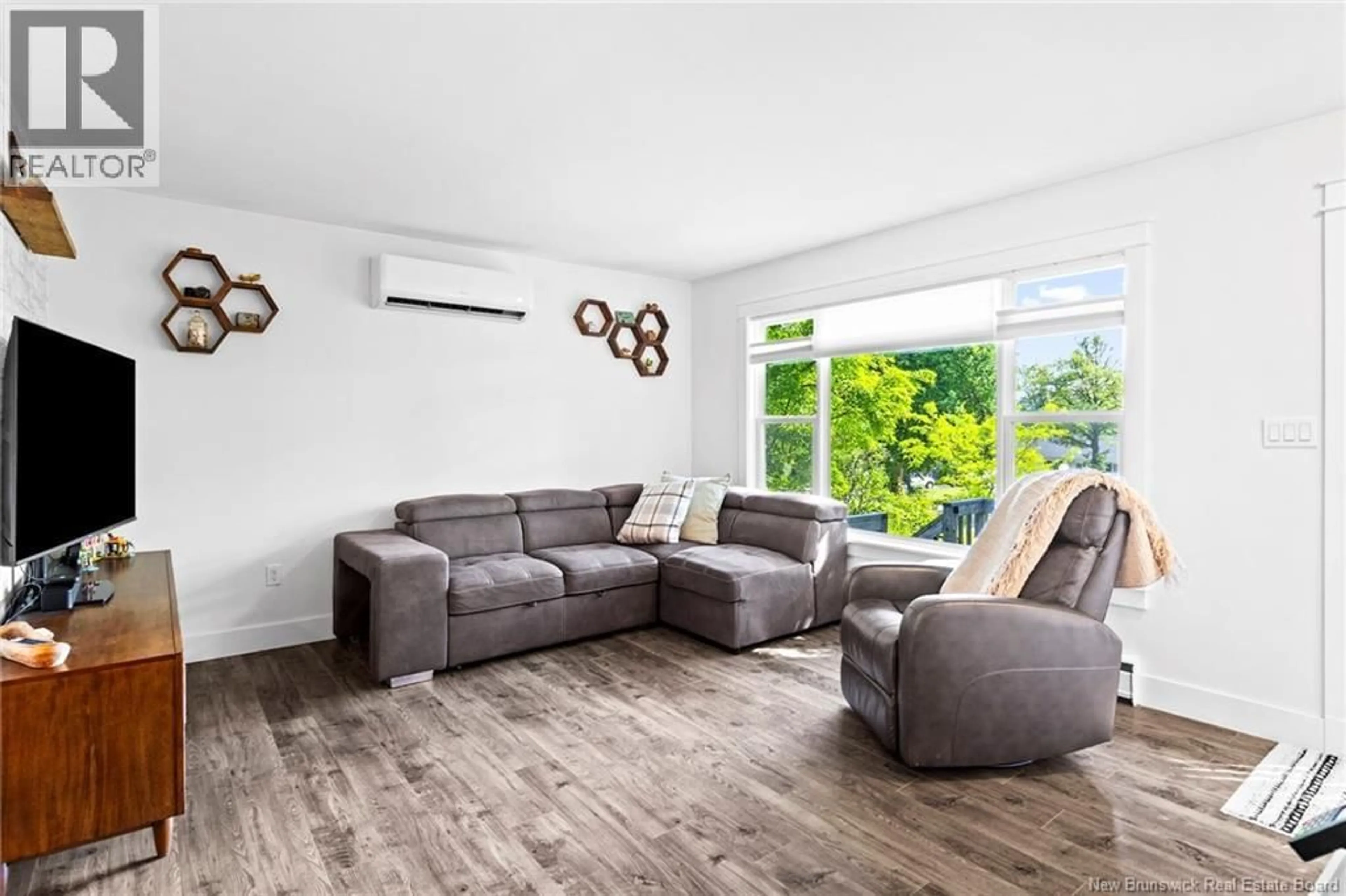 Living room with furniture, wood/laminate floor for 26 CHELSEA COURT, Fredericton New Brunswick E3B4N1