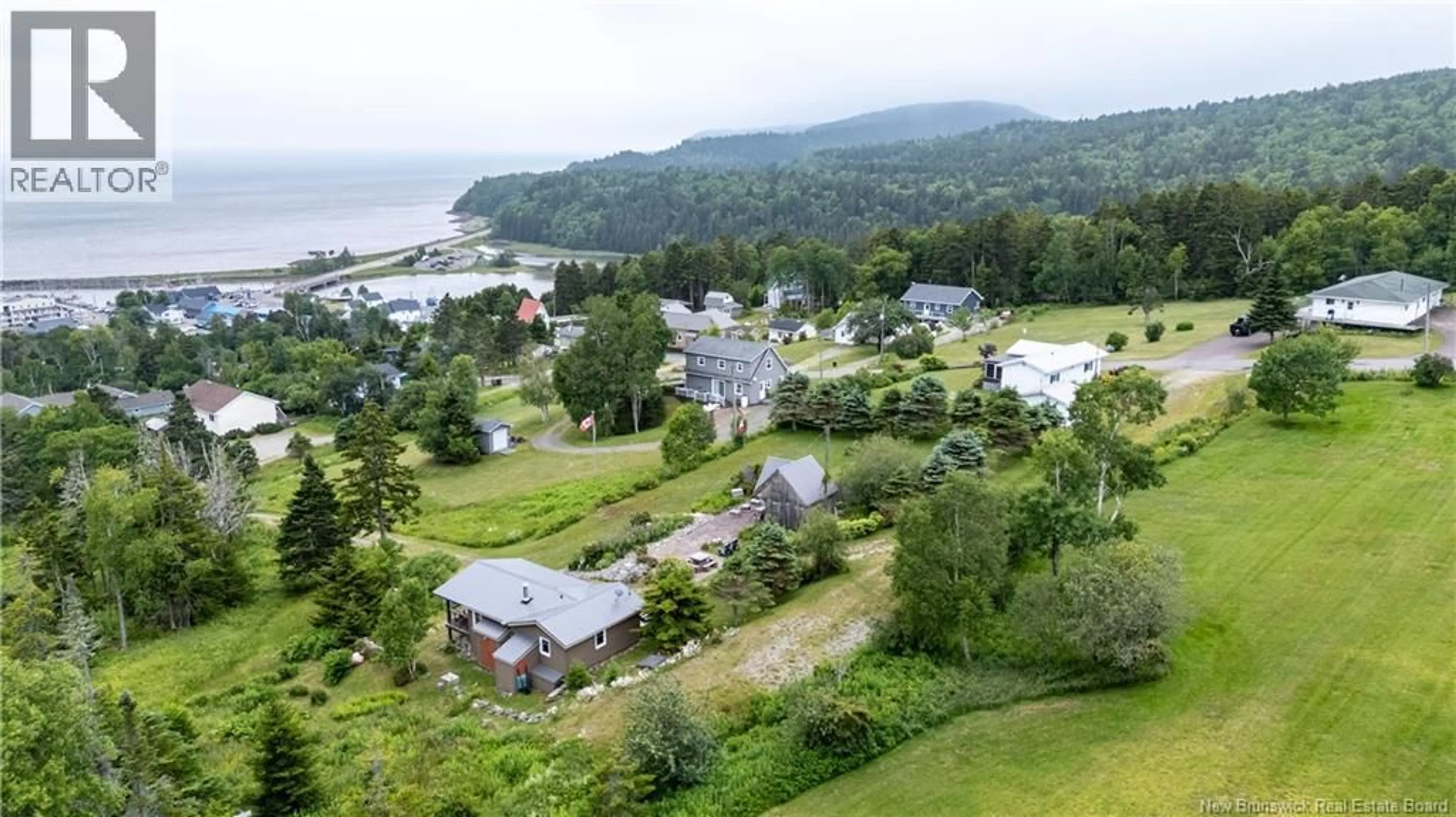 A pic from outside/outdoor area/front of a property/back of a property/a pic from drone, water/lake/river/ocean view for 100 SCHOOL STREET, Alma New Brunswick E4H1L1