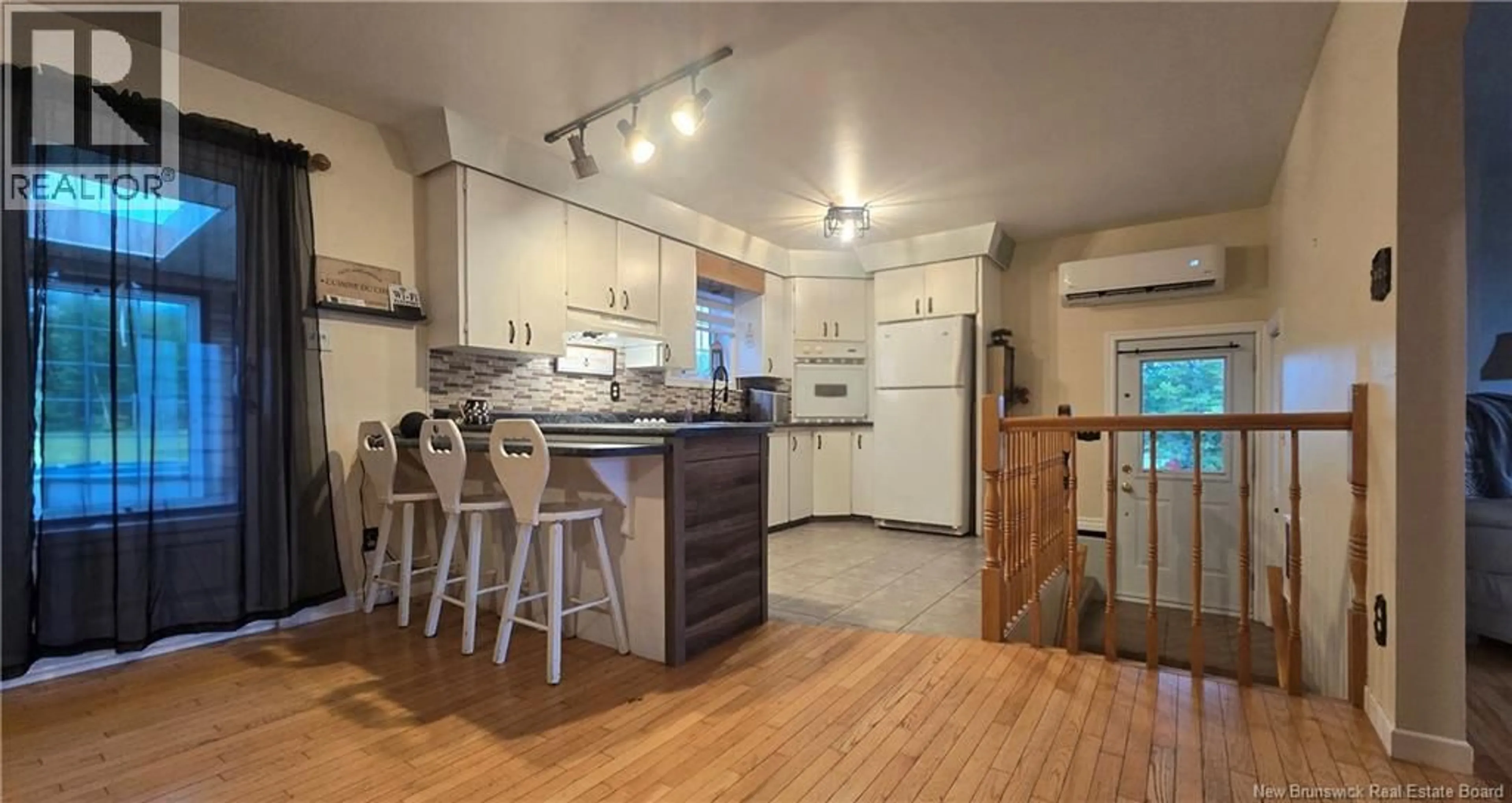 Open concept kitchen, wood/laminate floor for 12 BÉLANGER STREET, Saint-Arthur New Brunswick E3N5P1