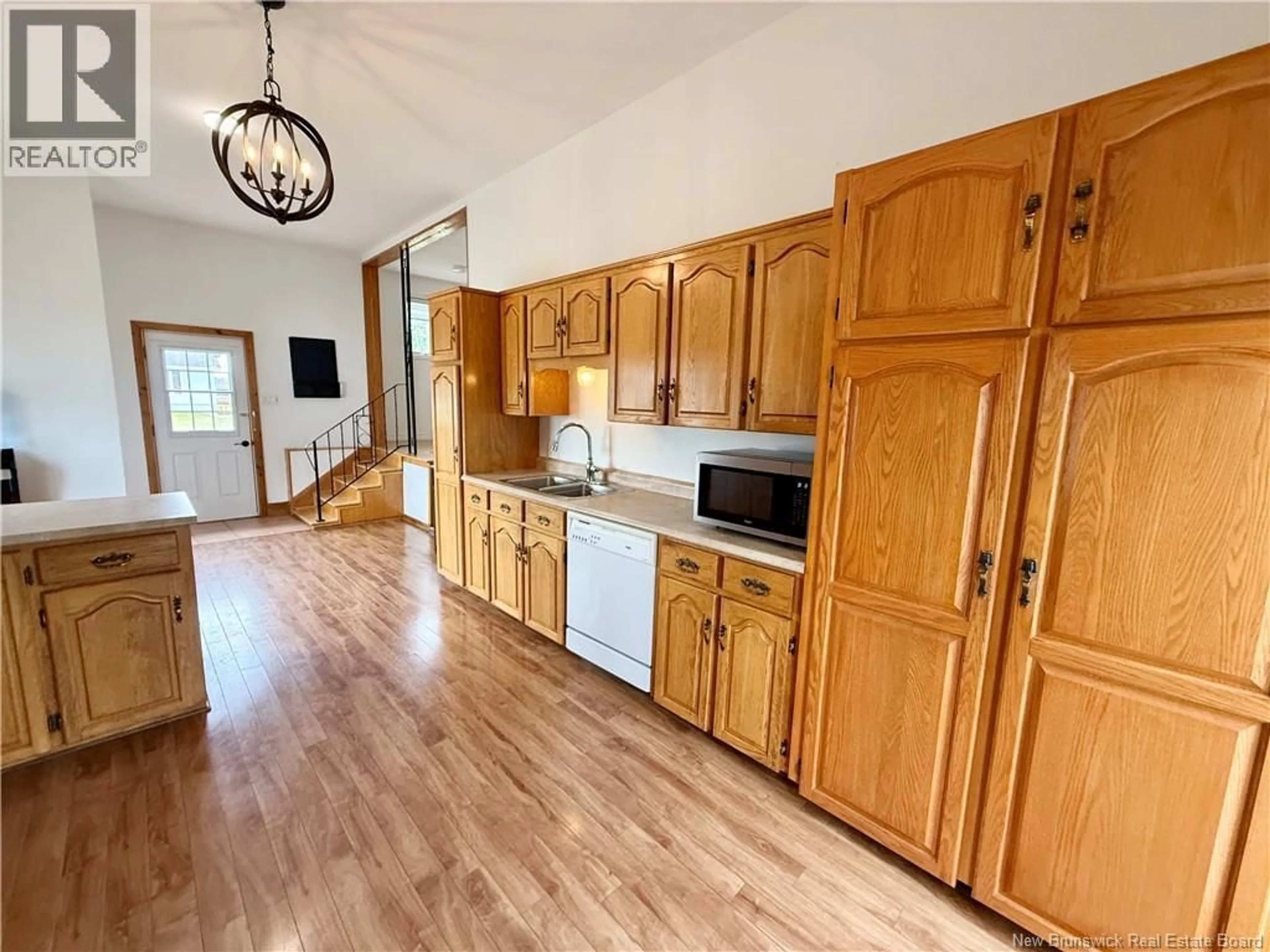 Open concept kitchen, wood/laminate floor for 102 NORMANDIE O, Petit-Rocher New Brunswick E8J1P3
