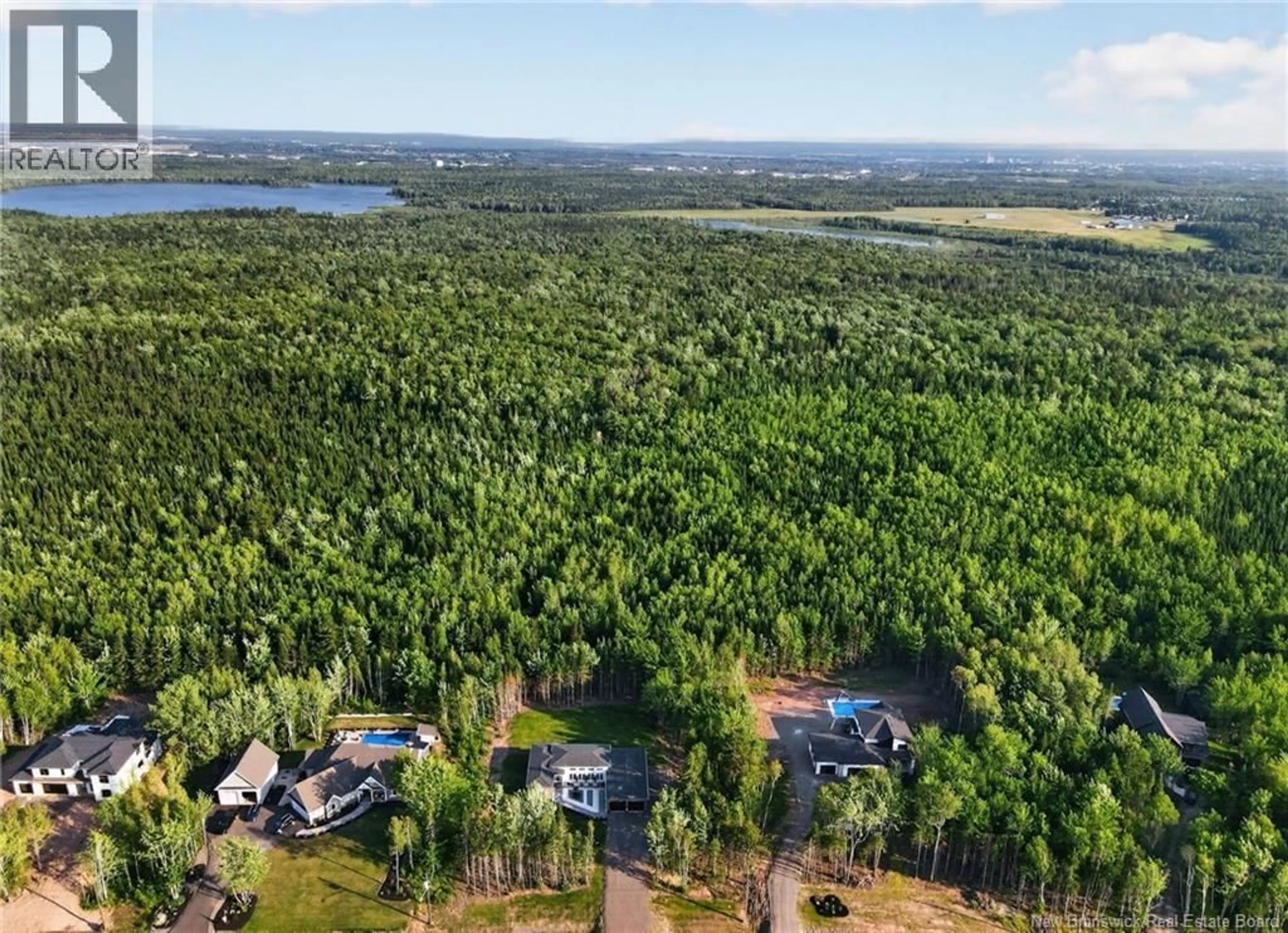 A pic from outside/outdoor area/front of a property/back of a property/a pic from drone, forest/trees view for 95 VIA ROMA WAY, Irishtown New Brunswick E1H0H9