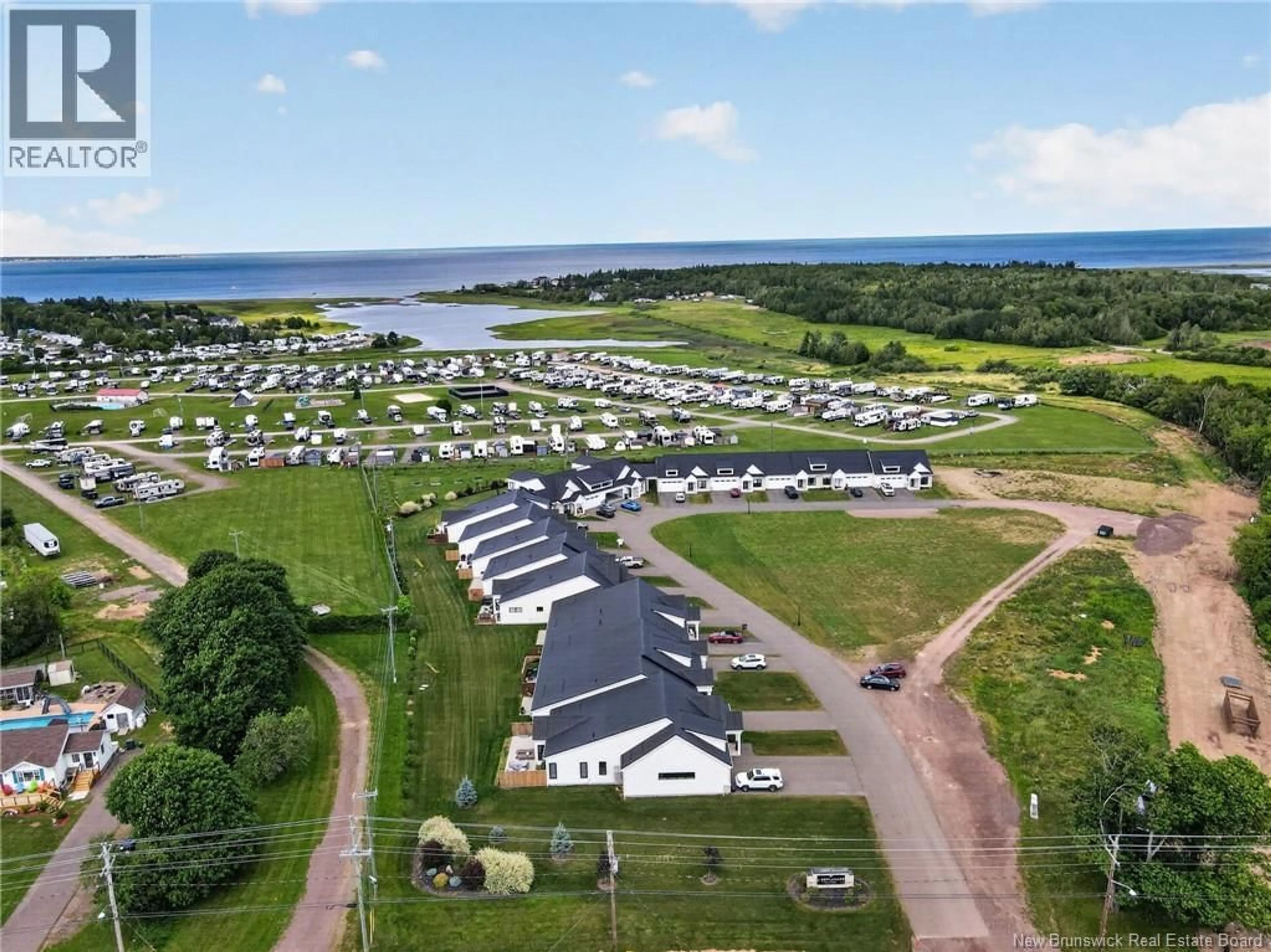 A pic from outside/outdoor area/front of a property/back of a property/a pic from drone, water/lake/river/ocean view for 106 - 724 ROUTE 133 ROAD, Pointe-Du-Chêne New Brunswick E4P5A3