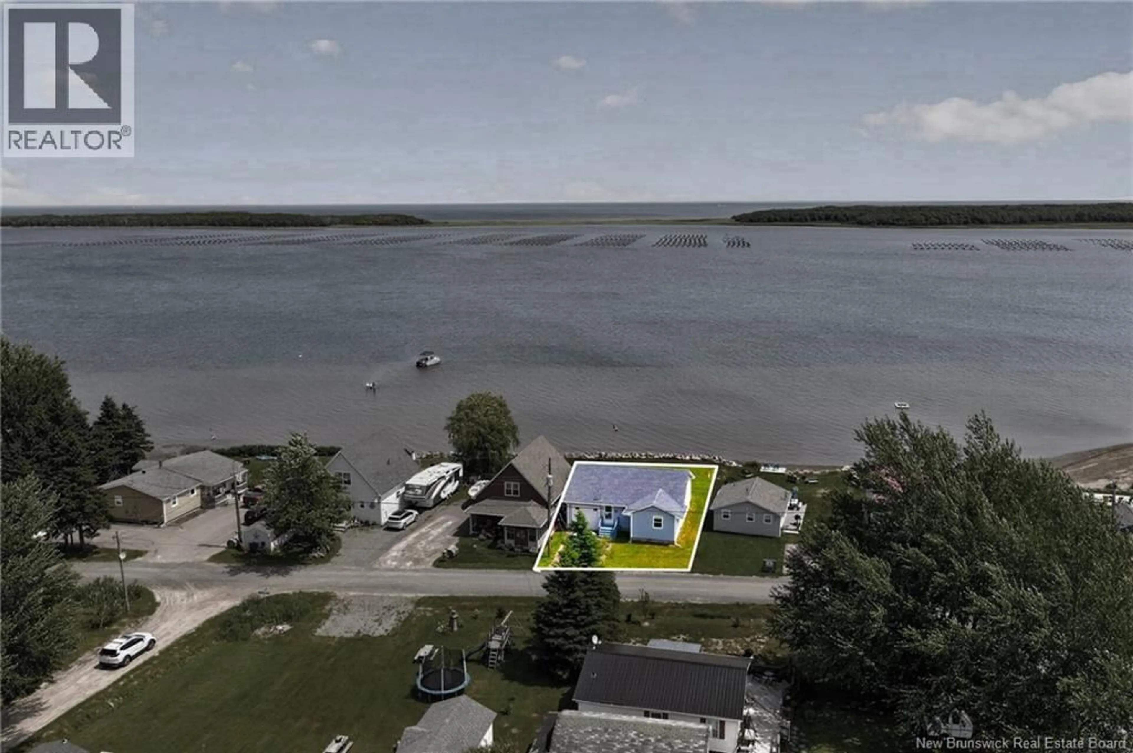 A pic from outside/outdoor area/front of a property/back of a property/a pic from drone, water/lake/river/ocean view for 6 DE LA MER BOULEVARD, Cocagne New Brunswick E4R2L9