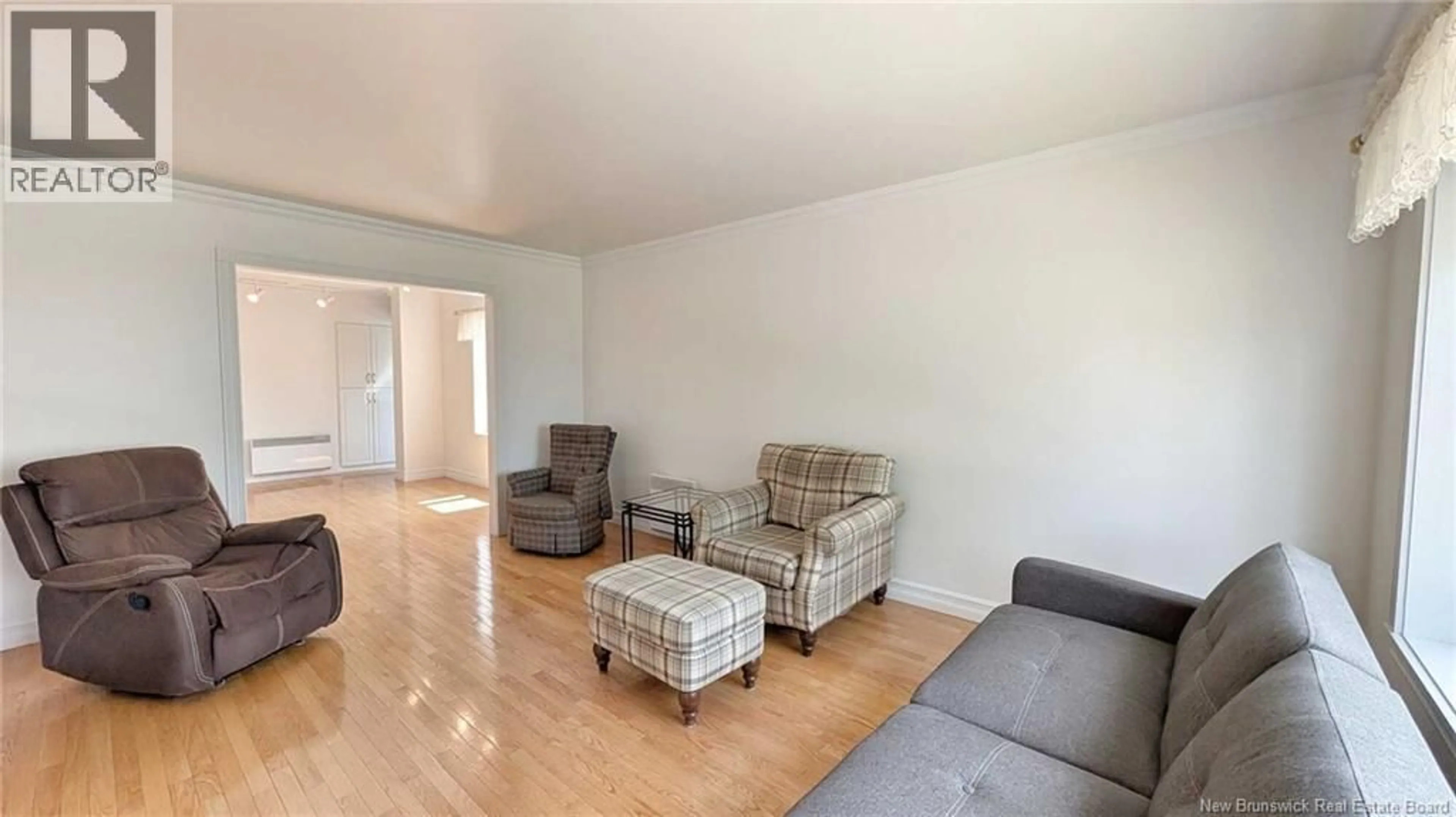 Living room with furniture, wood/laminate floor for 134 RUE 13, Shippagan New Brunswick E8S1C8
