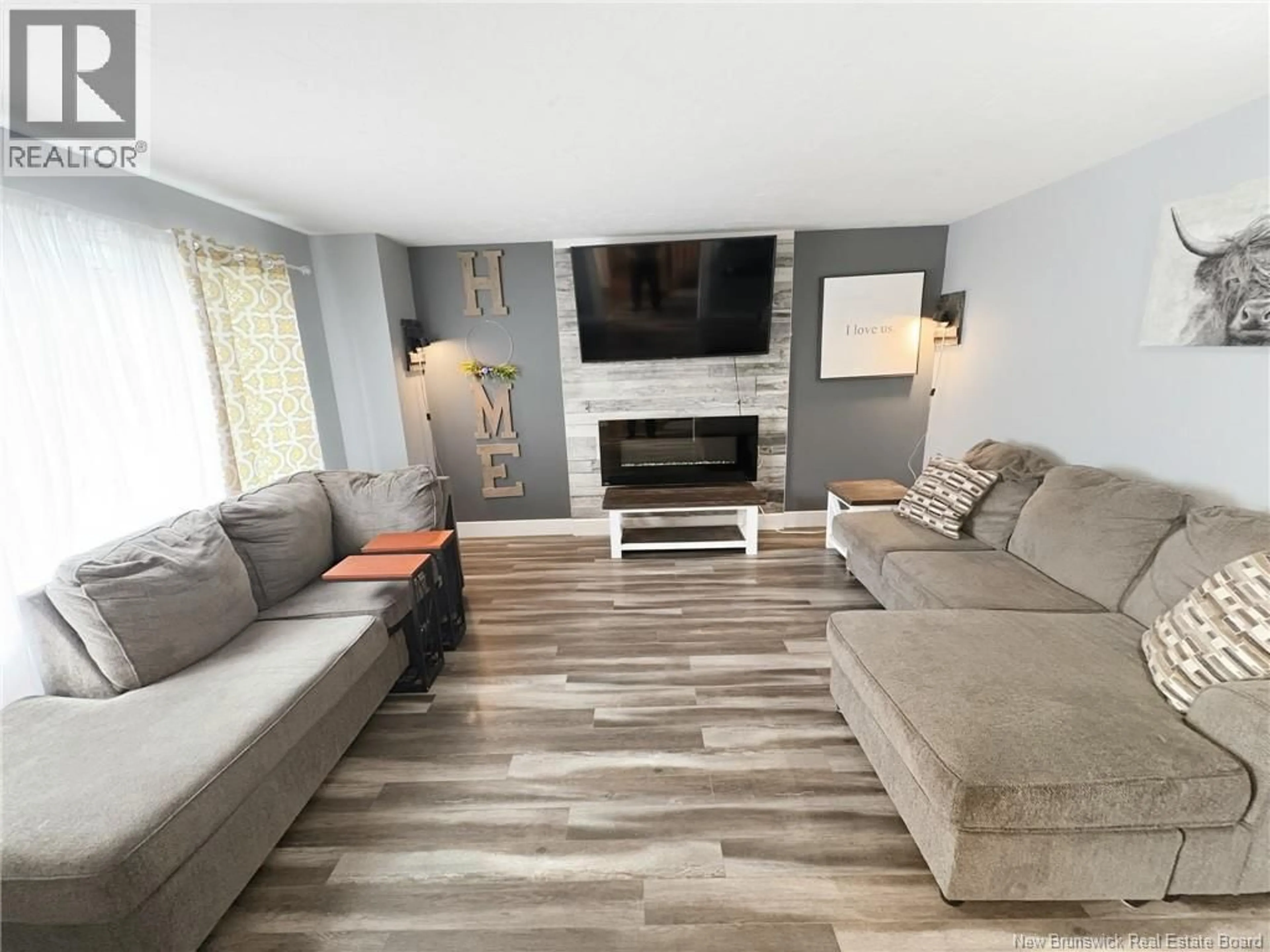Living room with furniture, wood/laminate floor for 46 SHEFFIELD COURT, Moncton New Brunswick E1G2J2