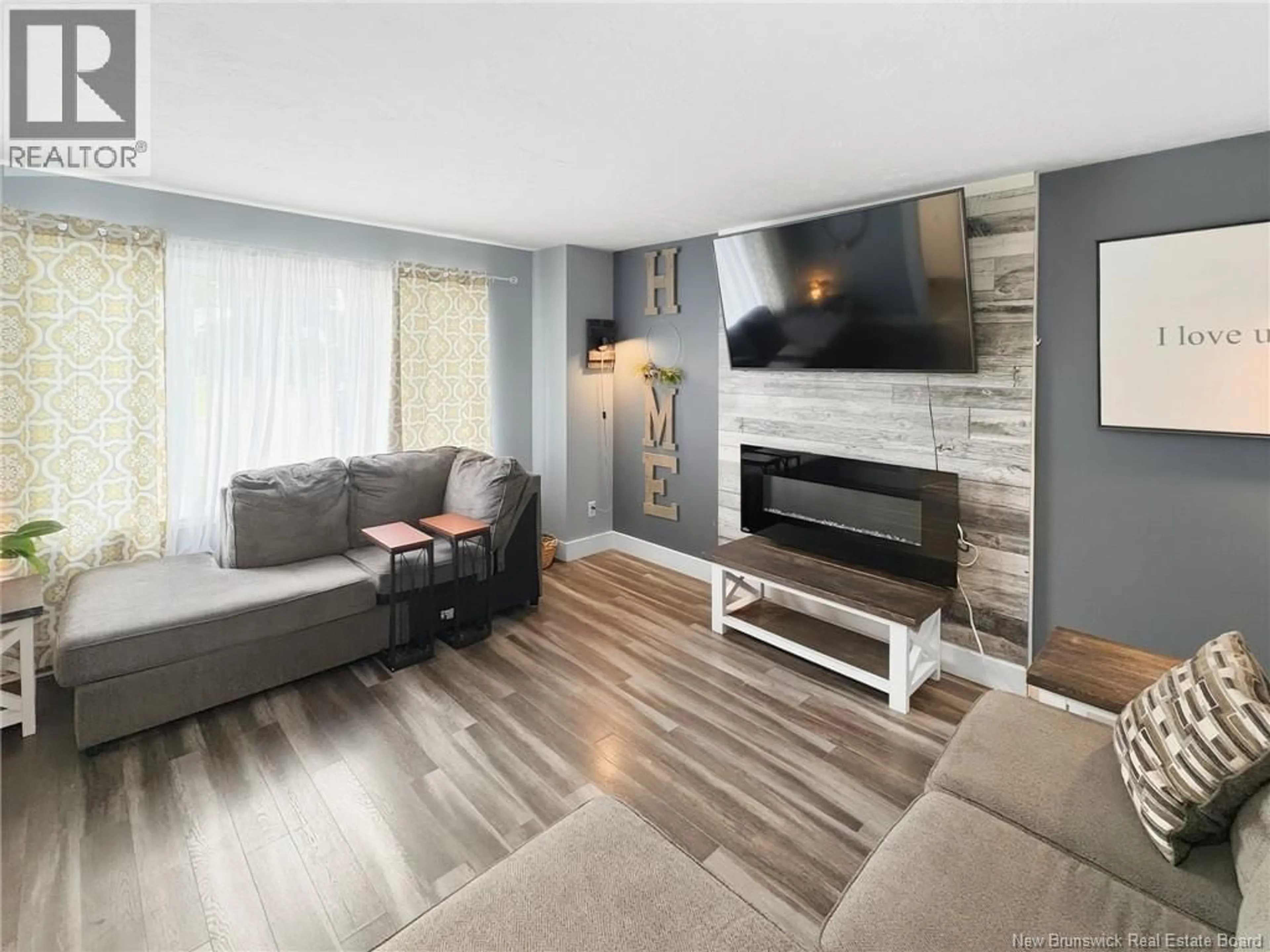 Living room with furniture, wood/laminate floor for 46 SHEFFIELD COURT, Moncton New Brunswick E1G2J2