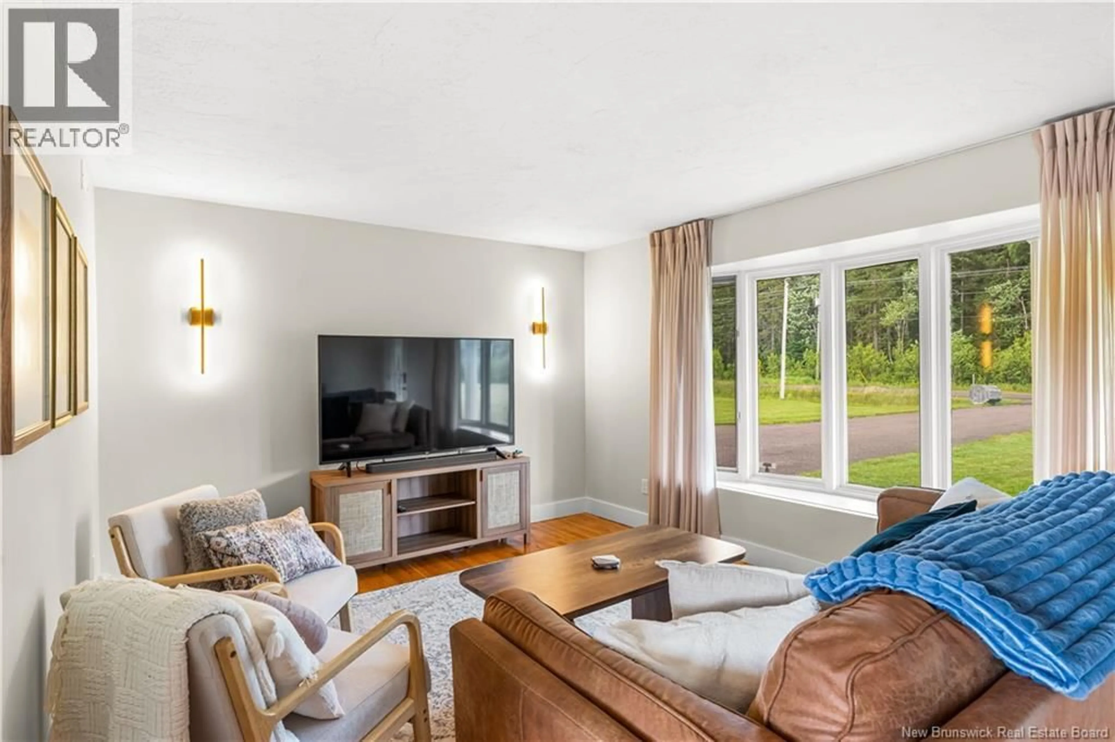Living room with furniture, wood/laminate floor for 4990 ROUTE 495, Sainte-Marie-De-Kent New Brunswick E4S1Z7