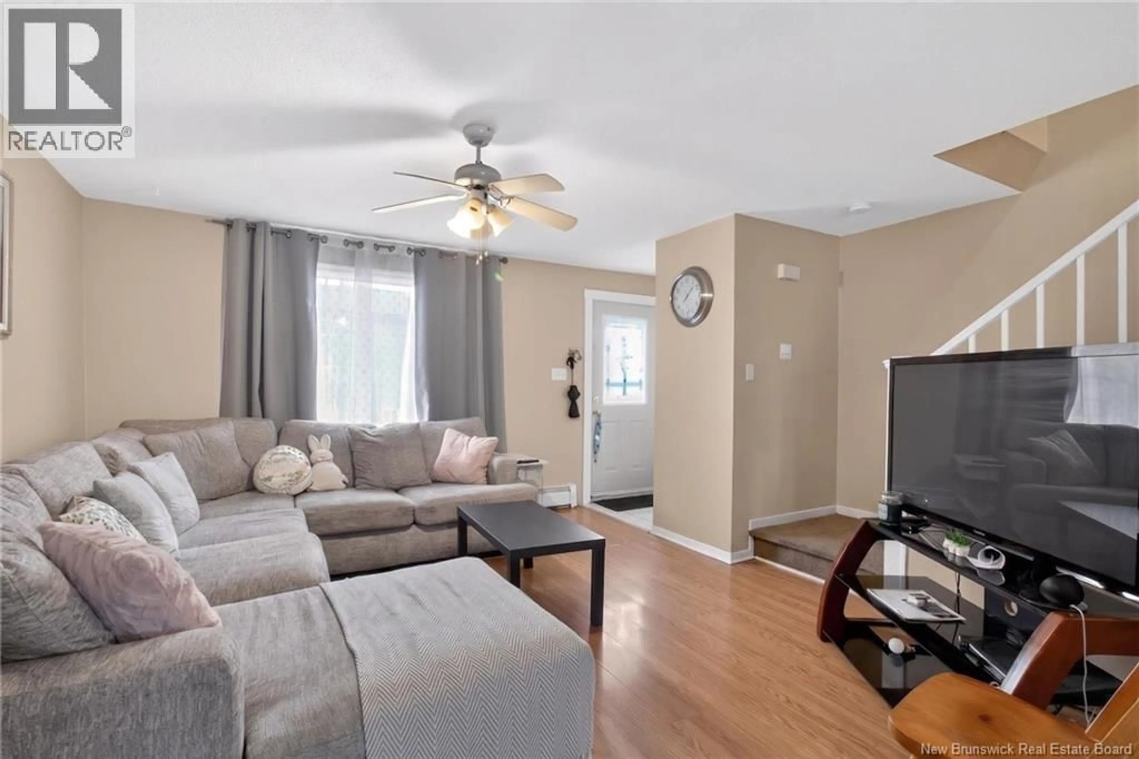 Living room with furniture, wood/laminate floor for 153-155 ARGYLE STREET, Moncton New Brunswick E1C3V1
