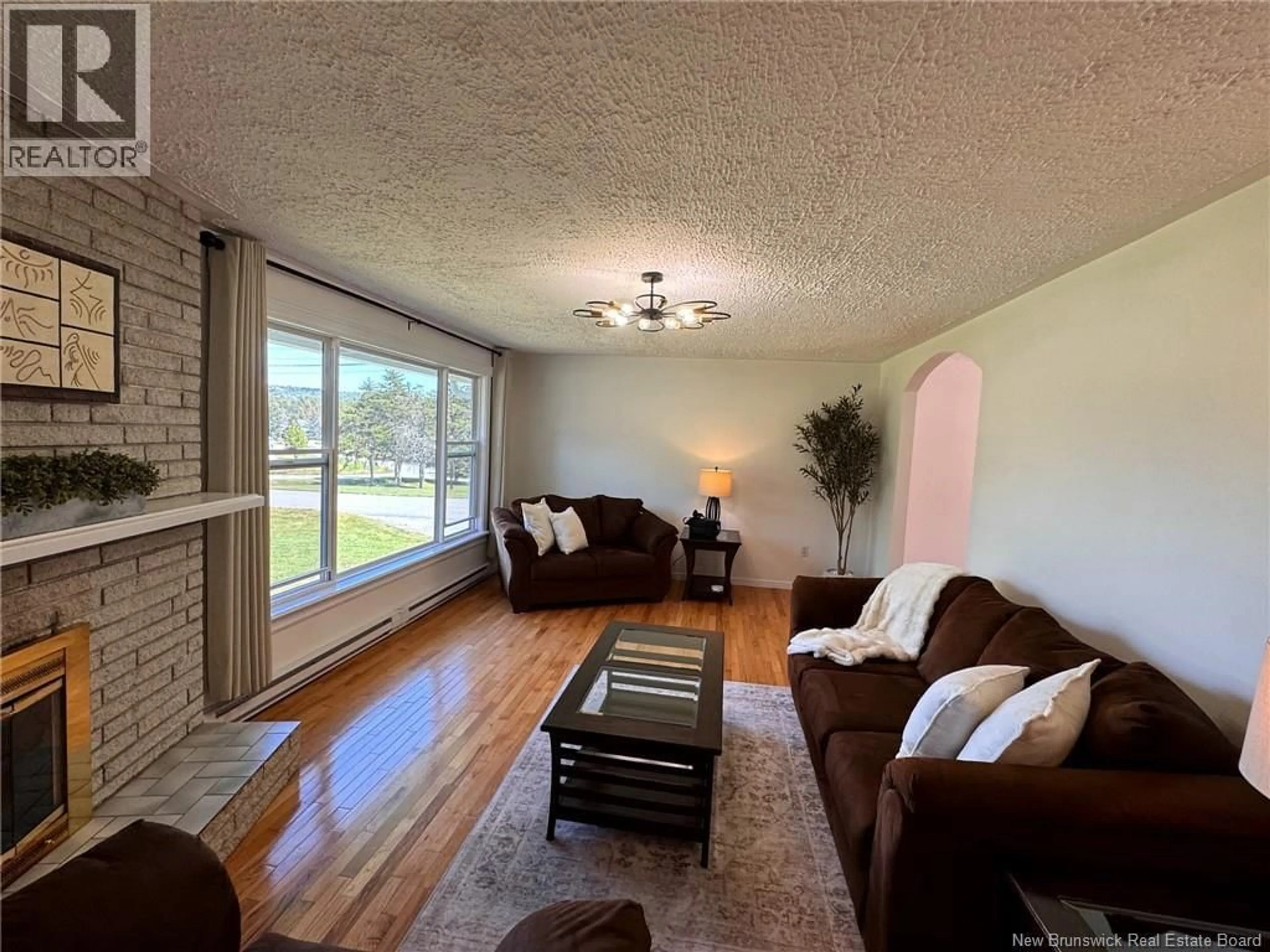 Living room with furniture, wood/laminate floor for 13 WOODWARD CRESCENT, Quispamsis New Brunswick E2E1N5