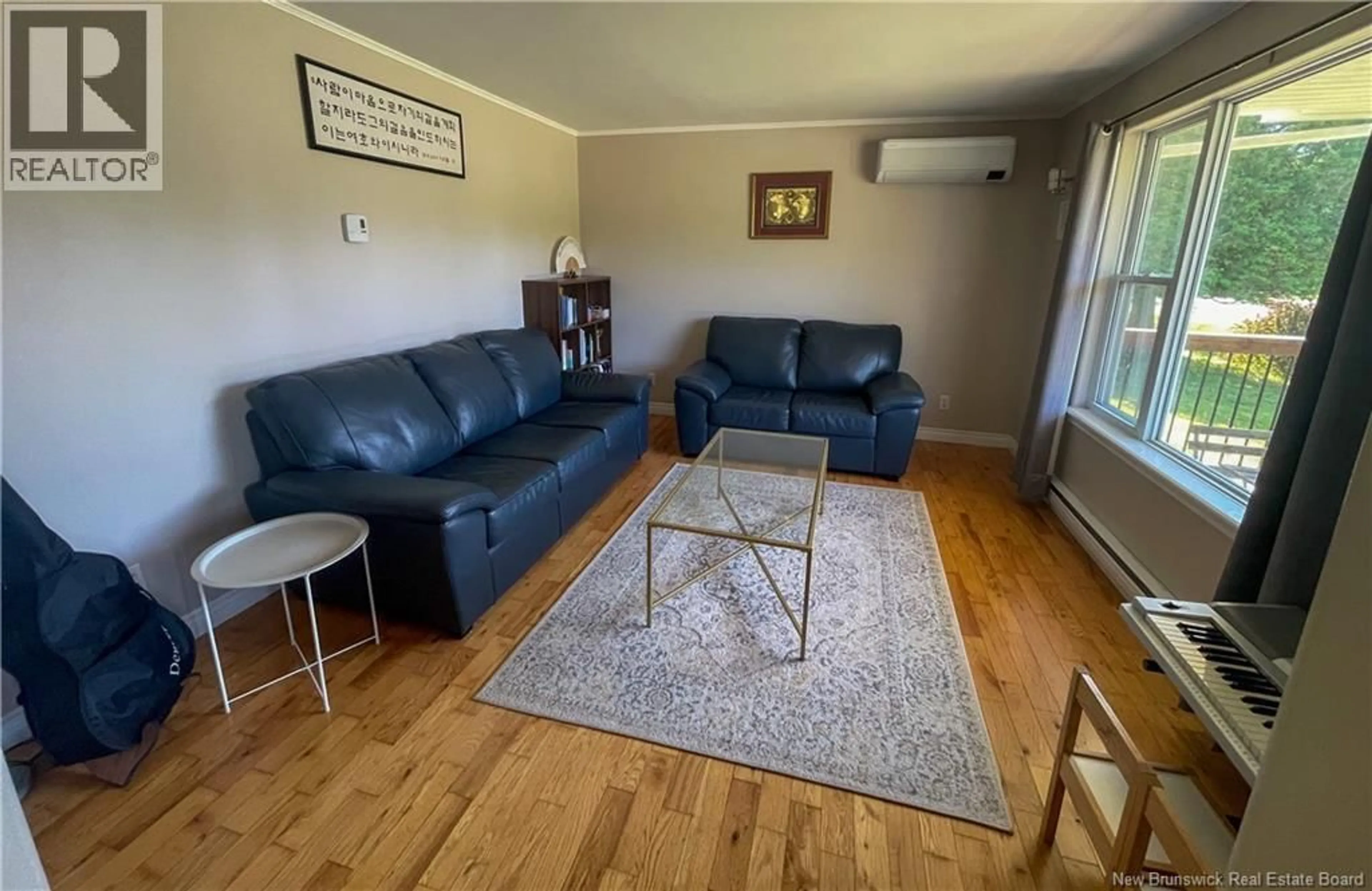 Living room with furniture, wood/laminate floor for 34 YUKON DRIVE, Quispamsis New Brunswick E2E5Y9