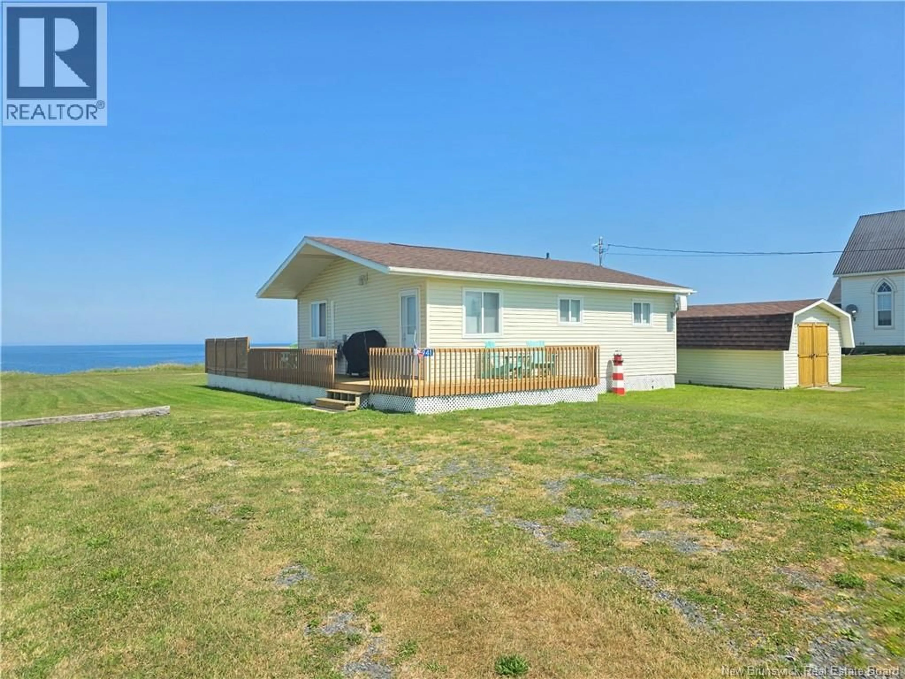 A pic from outside/outdoor area/front of a property/back of a property/a pic from drone, water/lake/river/ocean view for 5941 RTE 11, Janeville New Brunswick E2A5L1