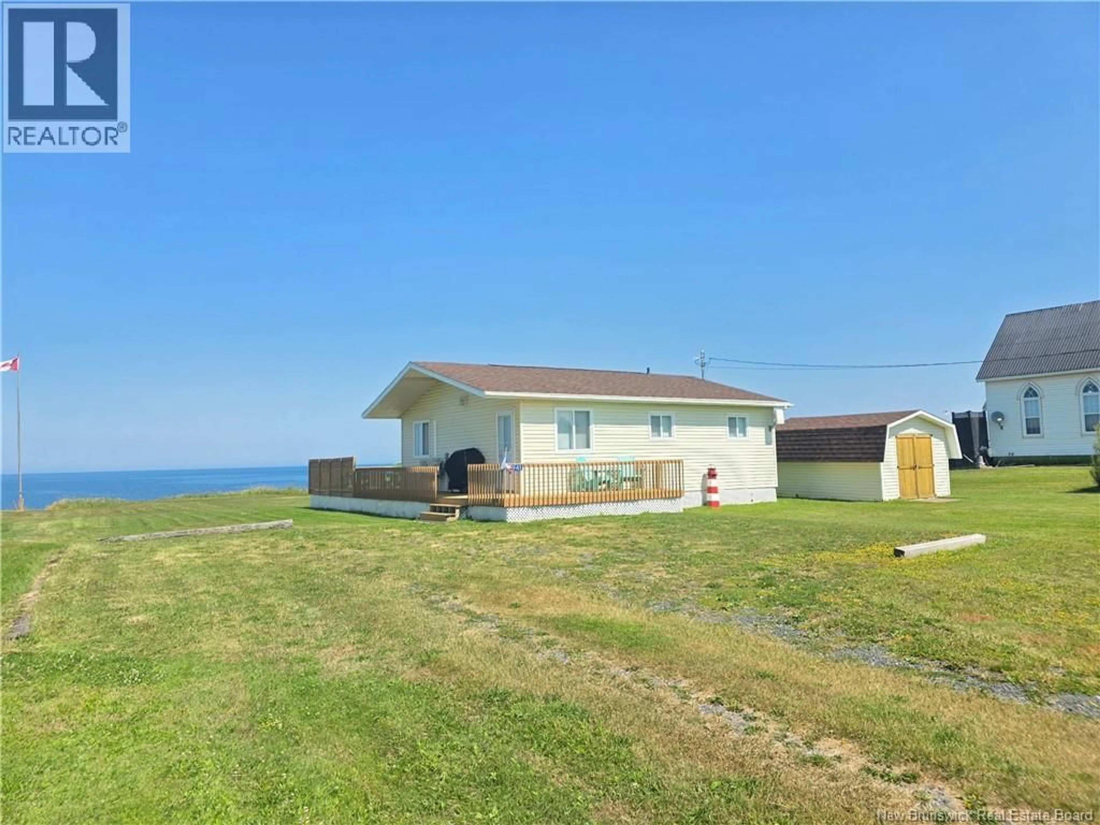 A pic from outside/outdoor area/front of a property/back of a property/a pic from drone, water/lake/river/ocean view for 5941 RTE 11, Janeville New Brunswick E2A5L1