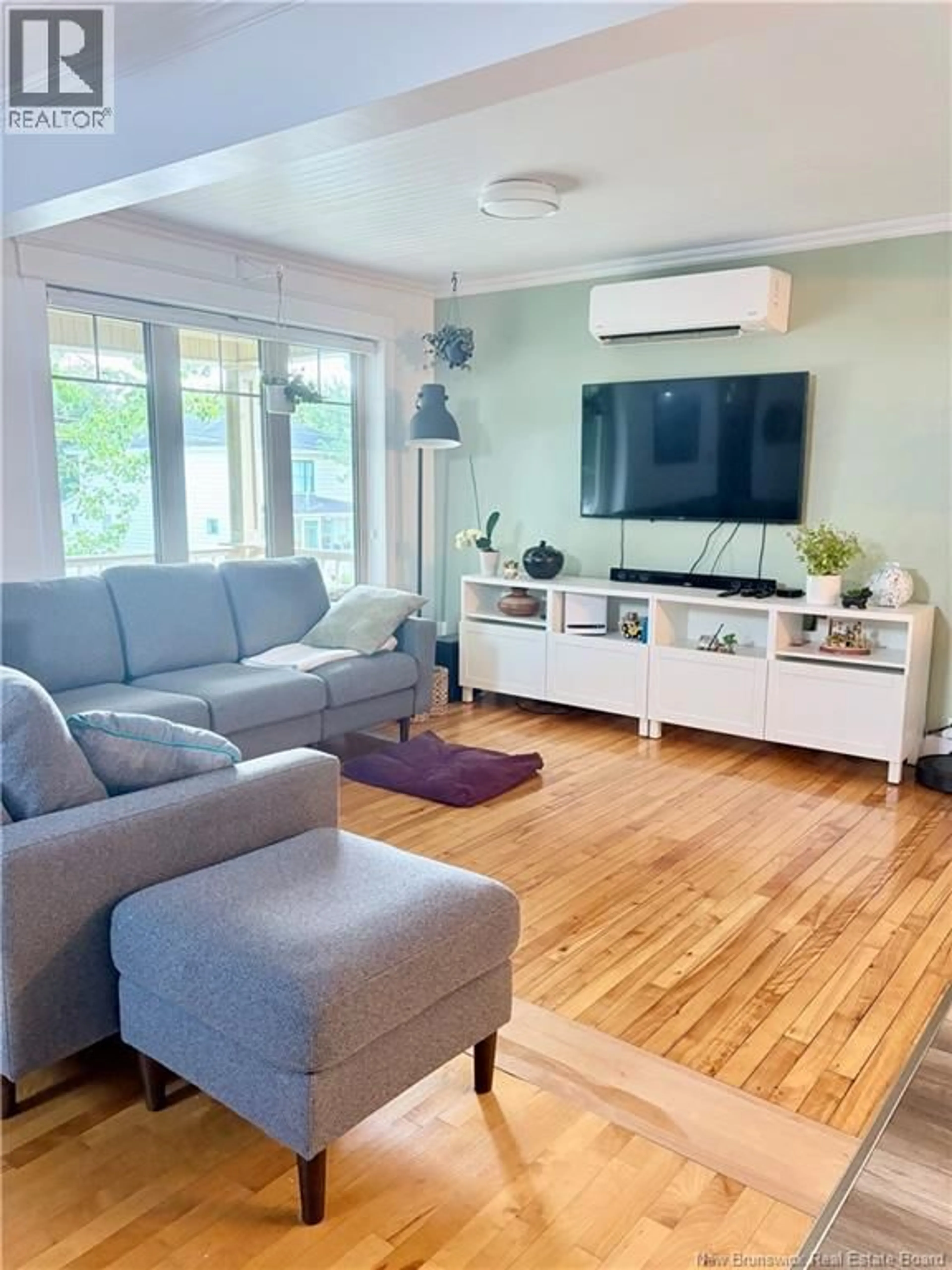 Living room with furniture, wood/laminate floor for 22 21E AVENUE, Edmundston New Brunswick E3V2B9