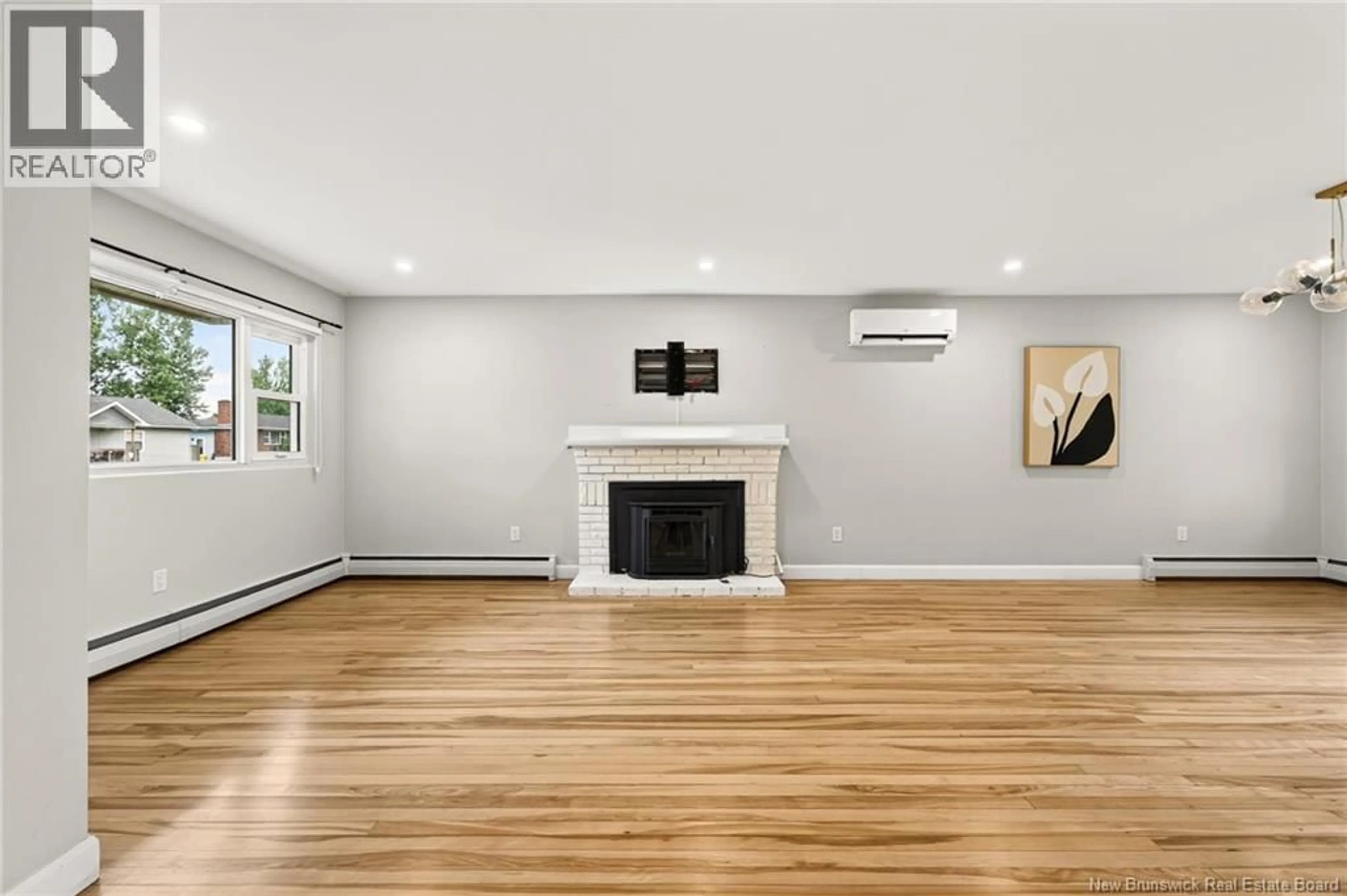 Living room with furniture, wood/laminate floor for 86 POIRIER DRIVE, Moncton New Brunswick E1C7R8