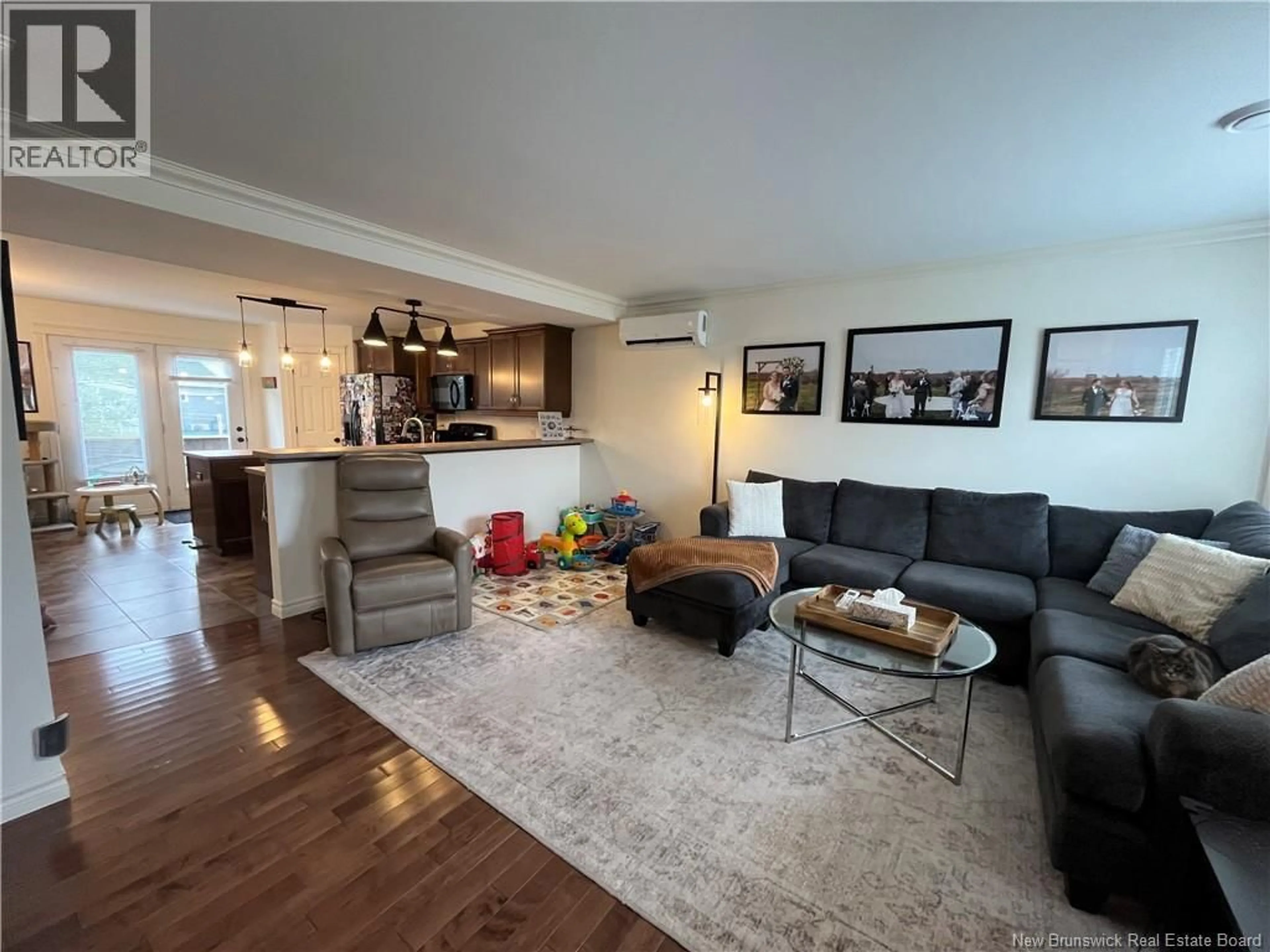 Living room with furniture, wood/laminate floor for 114 CORIANDER STREET, Moncton New Brunswick E1G0R8