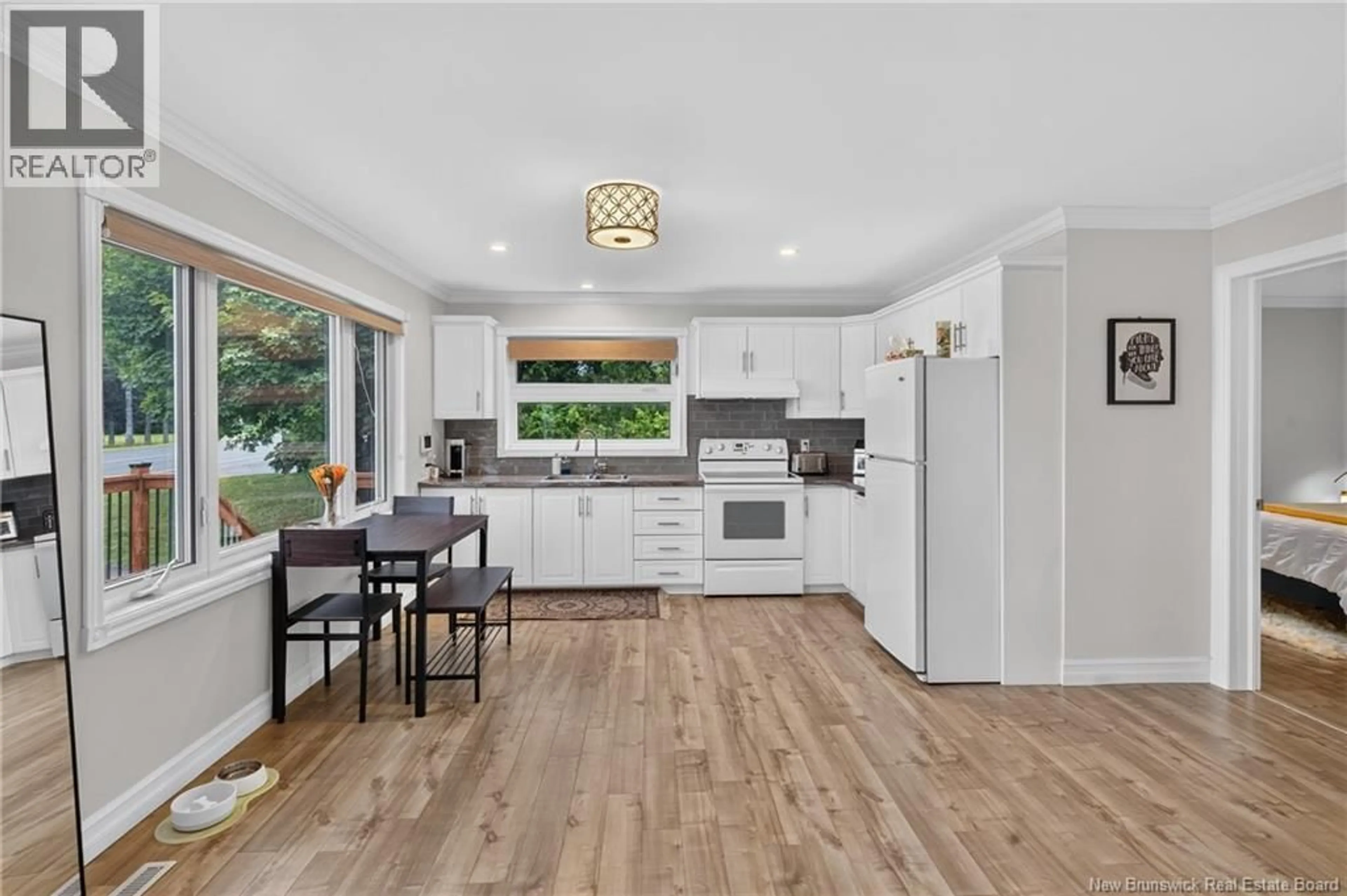 Open concept kitchen, wood/laminate floor for 1625 DES PIONNIERS AVENUE, Balmoral New Brunswick E8E1C1