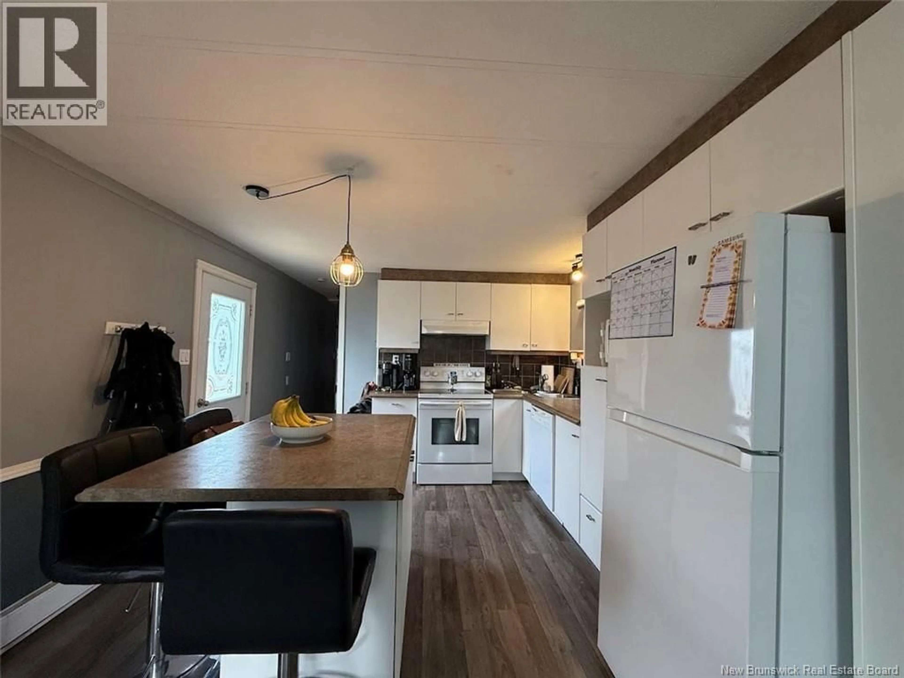 Open concept kitchen, wood/laminate floor for 18 PARC P'TISO STREET, Edmundston New Brunswick E3V3X7