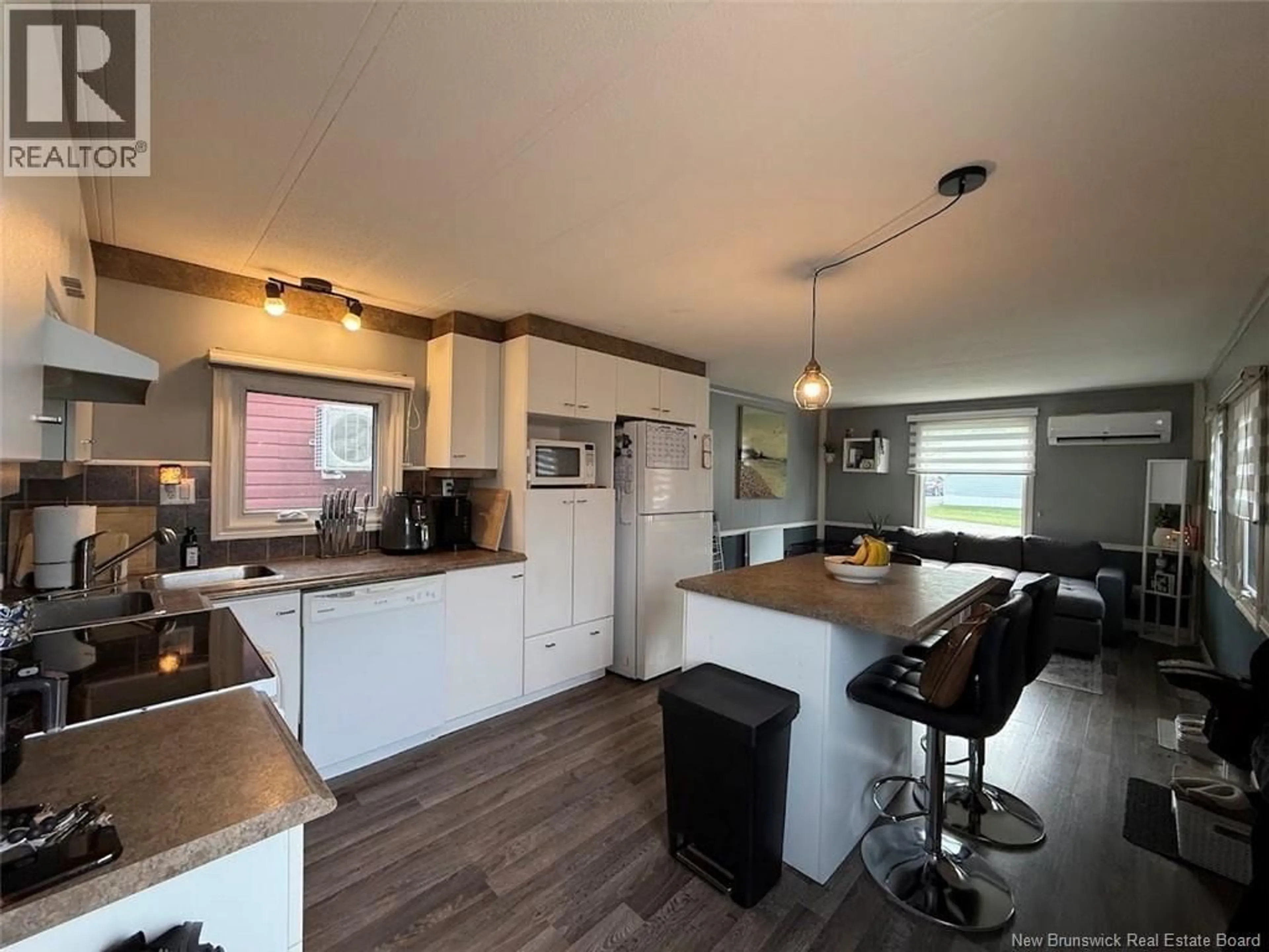 Open concept kitchen, wood/laminate floor for 18 PARC P'TISO STREET, Edmundston New Brunswick E3V3X7