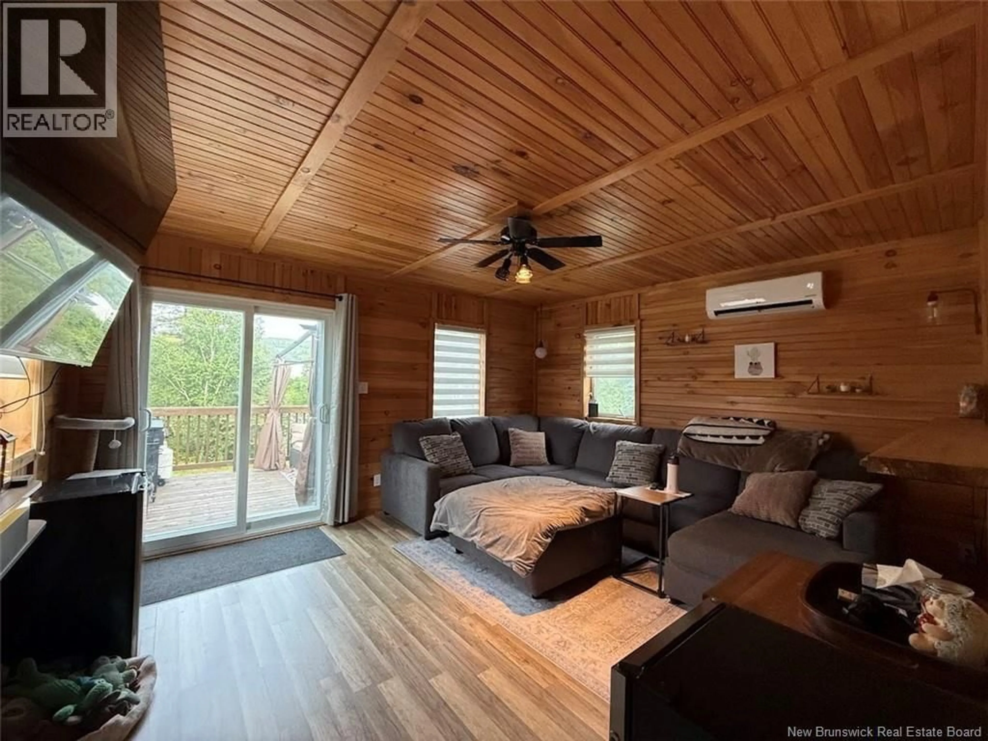 Living room with furniture, wood/laminate floor for 18 PARC P'TISO STREET, Edmundston New Brunswick E3V3X7