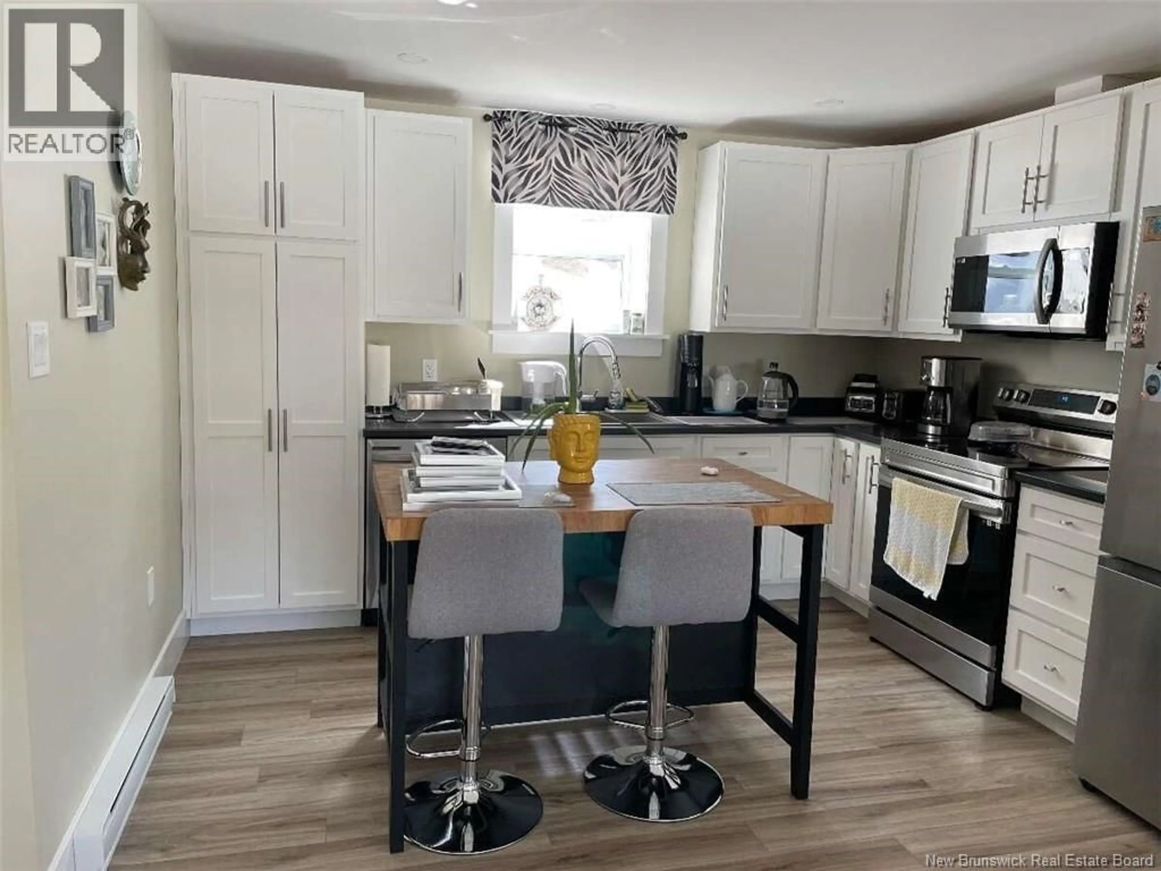 Open concept kitchen, wood/laminate floor for 67 DEWITT ACRES, Fredericton New Brunswick E3A6S3