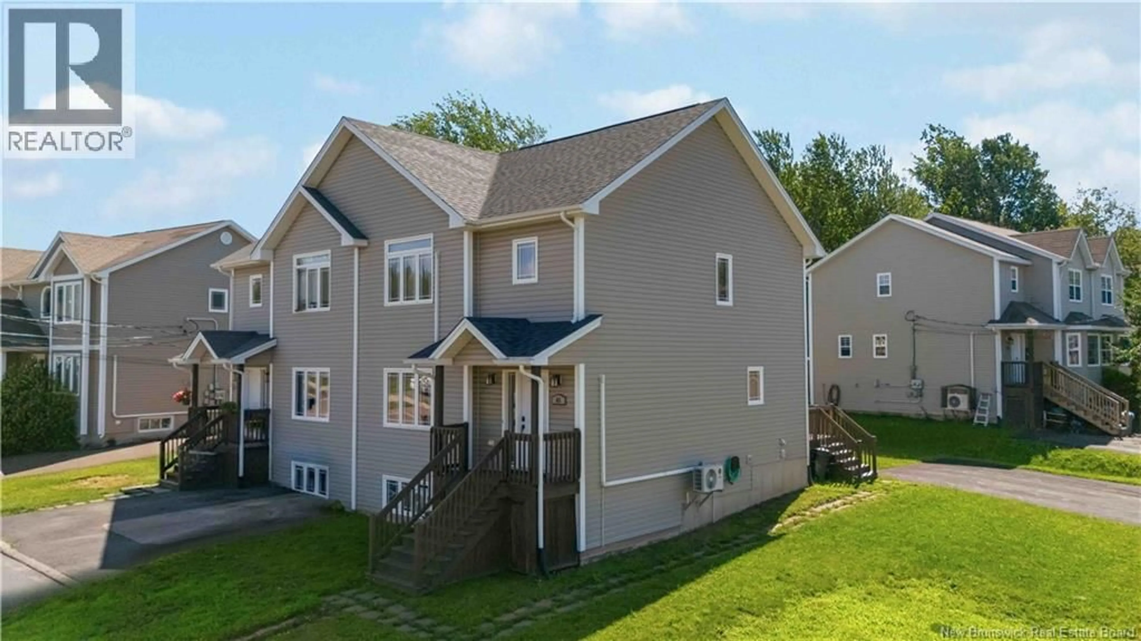 Home with vinyl exterior material, street for 65 BELLE-FORET, Dieppe New Brunswick E1A8Y2