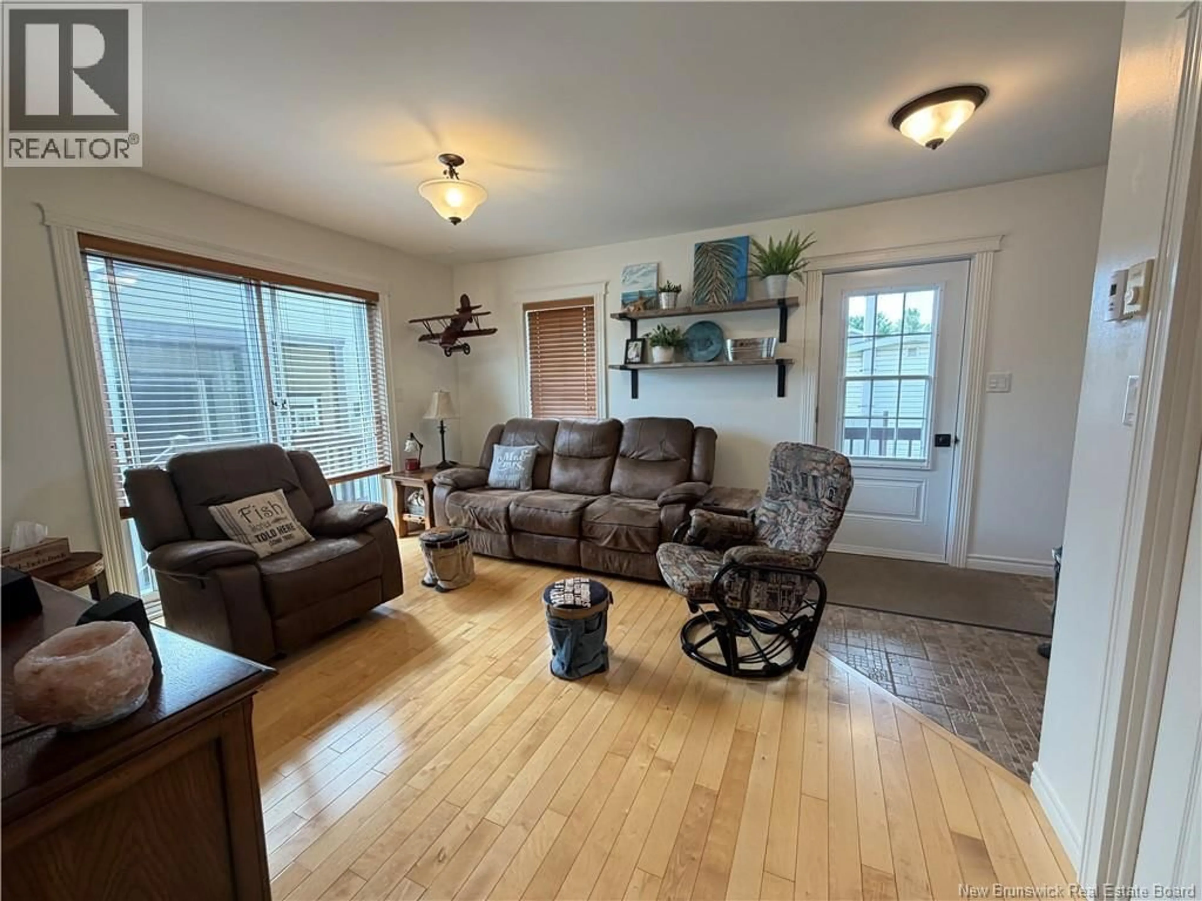 Living room with furniture, wood/laminate floor for 50 RUE VALCOURT RUE, Saint-Quentin New Brunswick E8A2B3