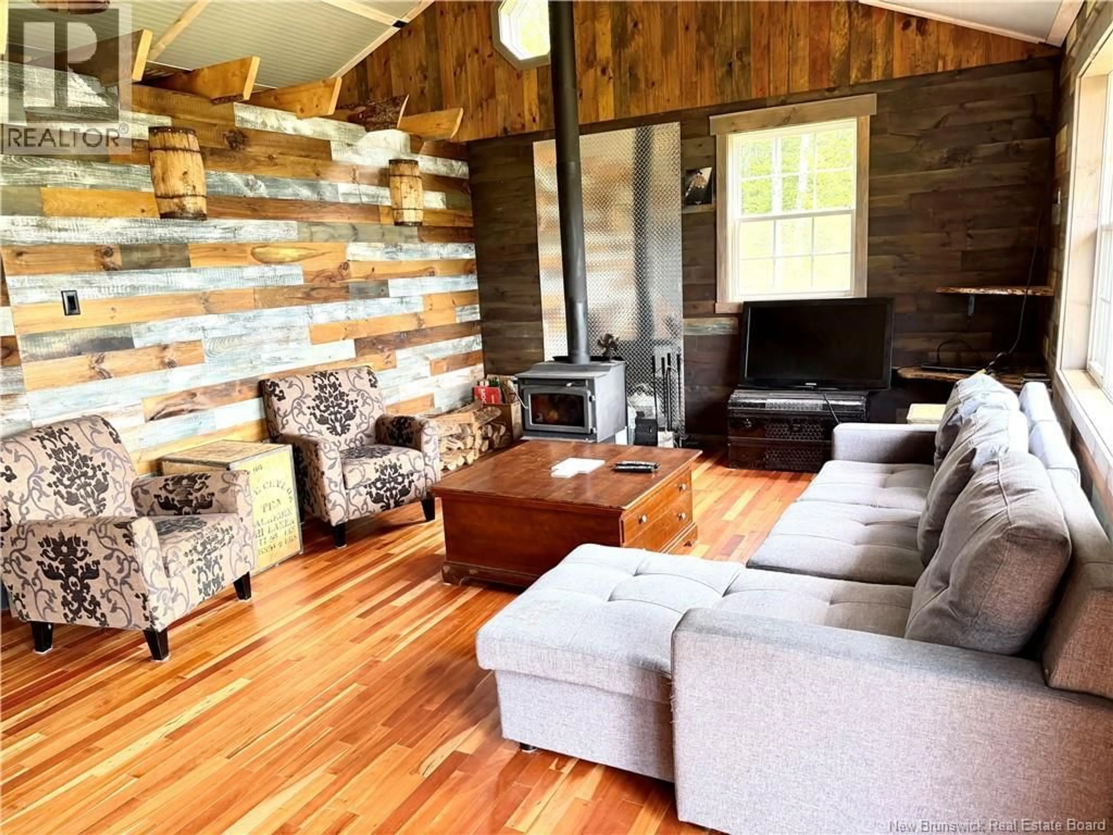 Living room with furniture, wood/laminate floor for LAKE ROAD, South Oromocto Lake New Brunswick E5L2R2