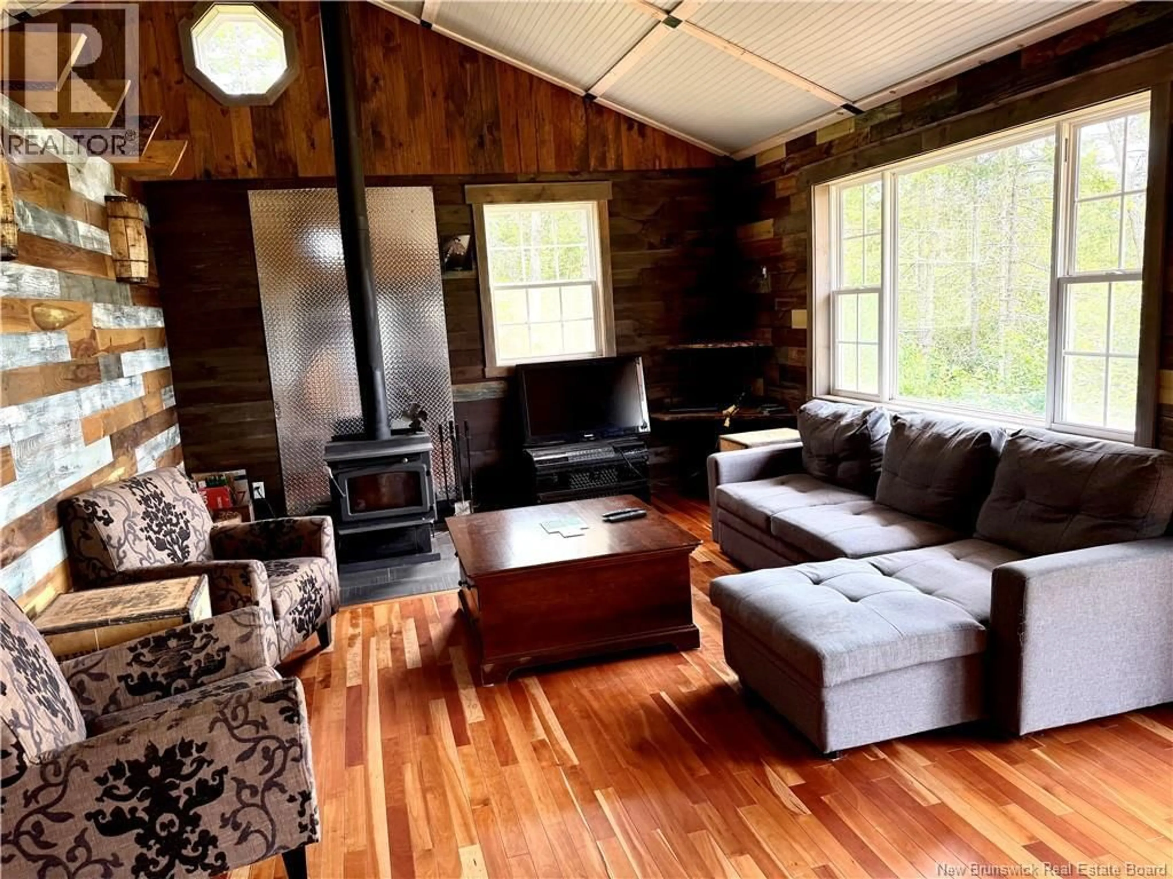 Living room with furniture, wood/laminate floor for LAKE ROAD, South Oromocto Lake New Brunswick E5L2R2