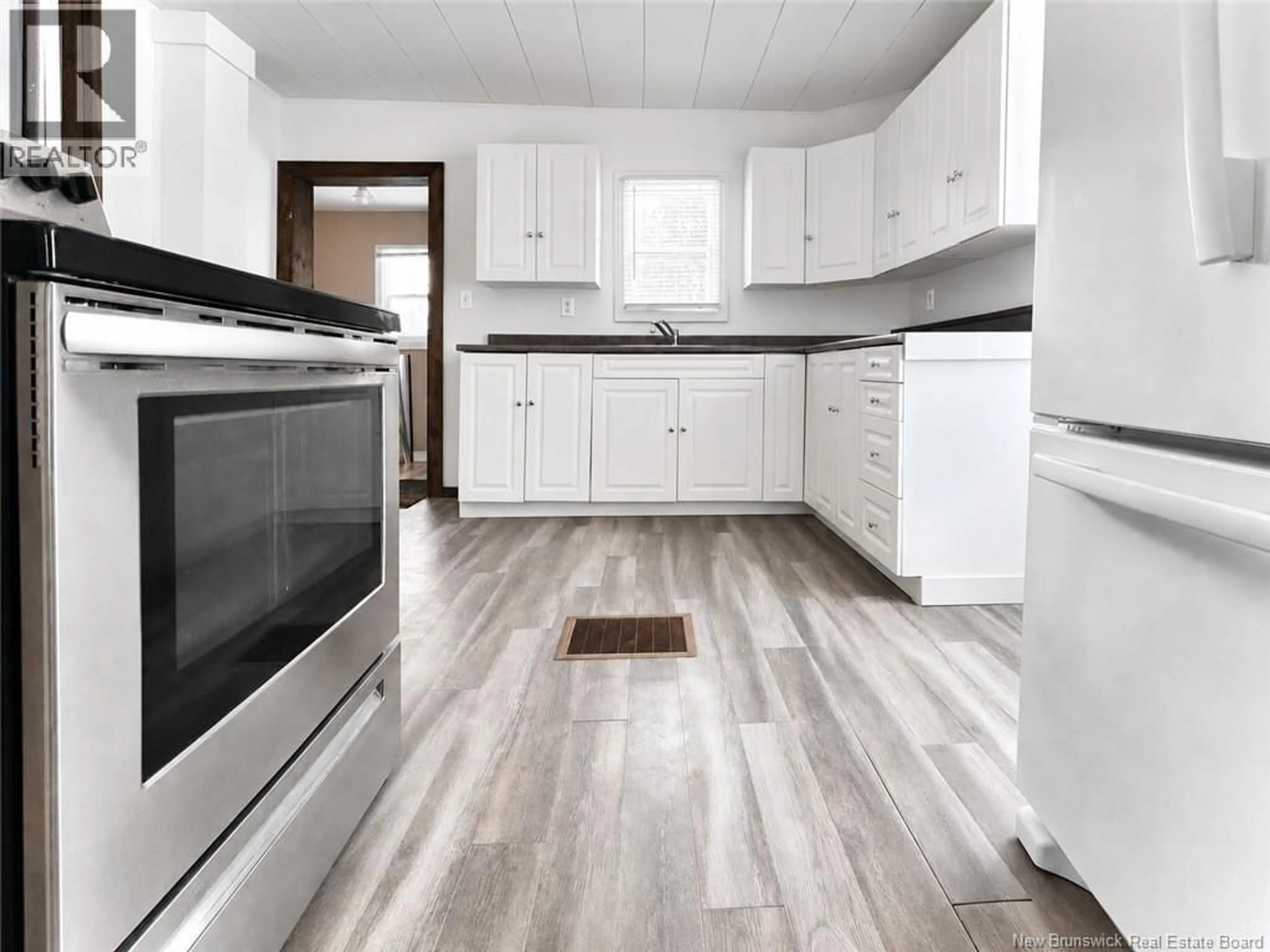 Open concept kitchen, wood/laminate floor for 16 HIGHFIELD STREET, Miramichi New Brunswick E1N4J3