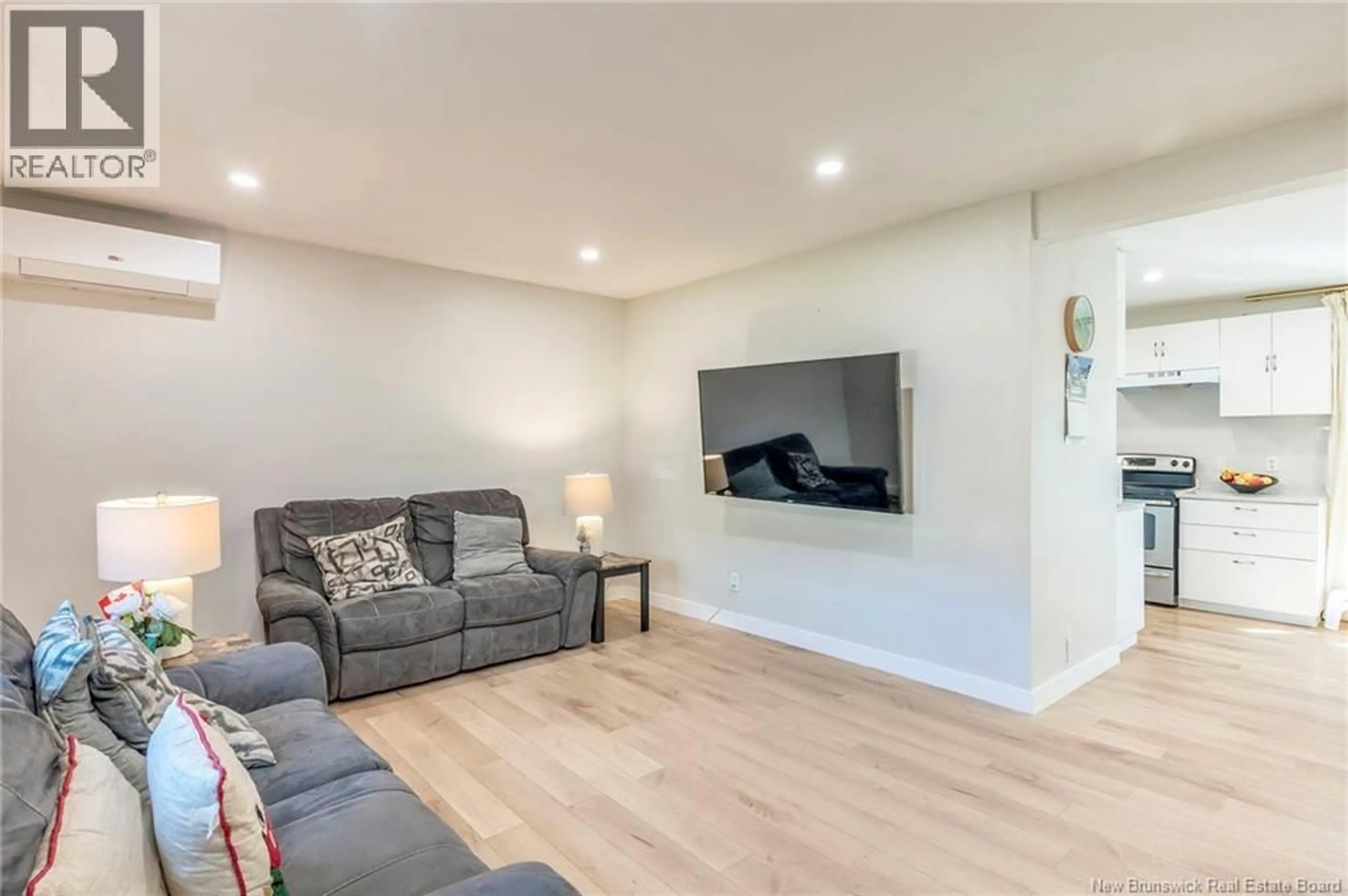 Living room with furniture, wood/laminate floor for 21 MOUNT ROYAL BOULEVARD, Moncton New Brunswick E1E2T9
