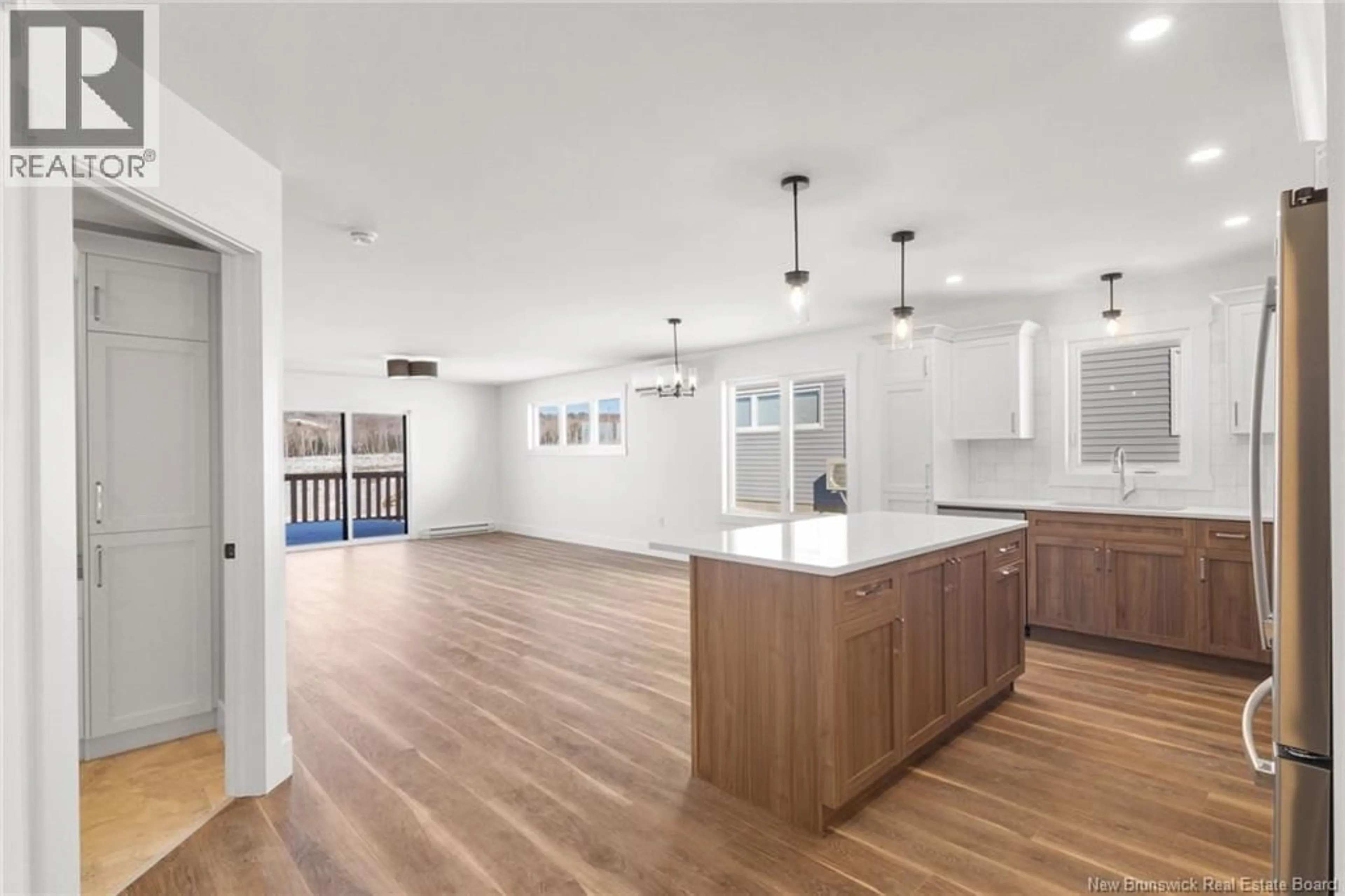 Open concept kitchen, wood/laminate floor for 93 ATTENBOROUGH DRIVE, Fredericton New Brunswick E3A9R6